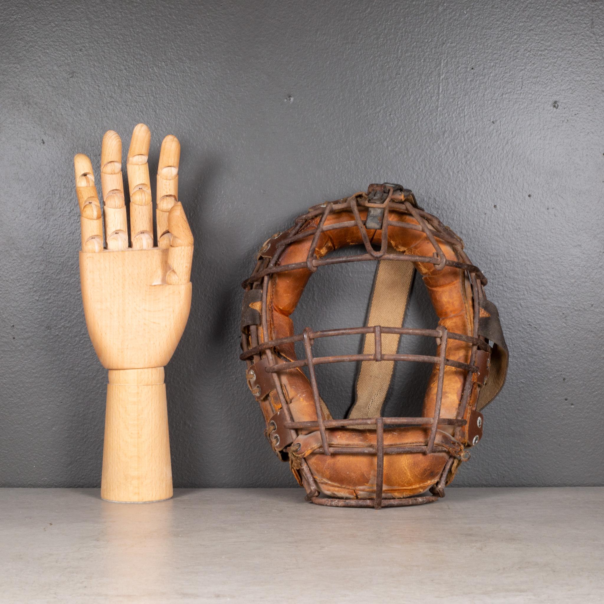 ABOUT

An original vintage catcher's mask by Wilson. The main body is carbon steel with thick, tan leather padding. The padding is held onto the body of the mask by brown leather straps and rawhide laced through grommets. The Wilson label is affixed