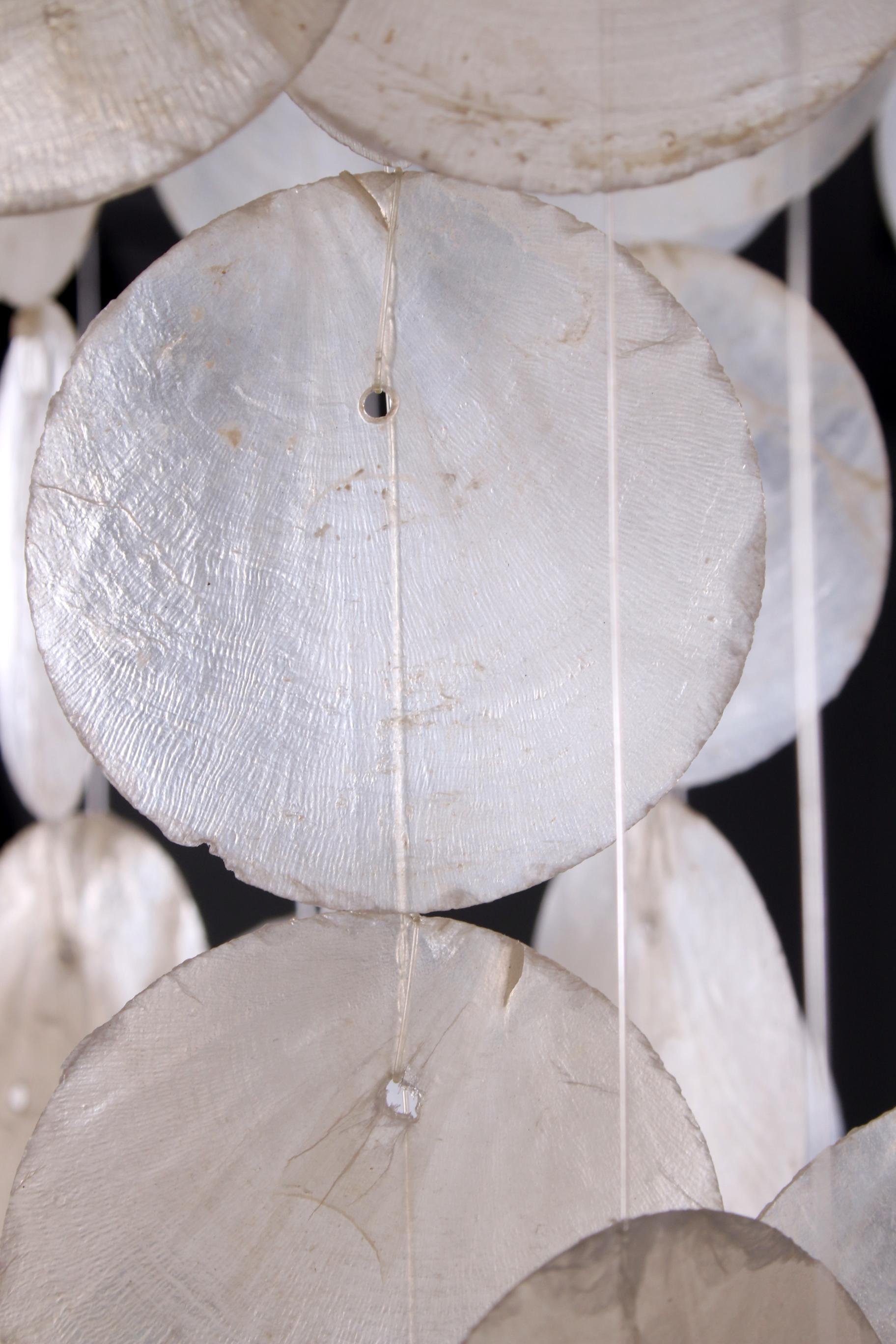 With this beautiful vintage shell storm catcher in the style of Verner Panton you imagine yourself in tropical atmospheres. This shell hanging wind catcher gives 'a kind of' holiday feeling in your interior, a real vintage eye-catcher that fits