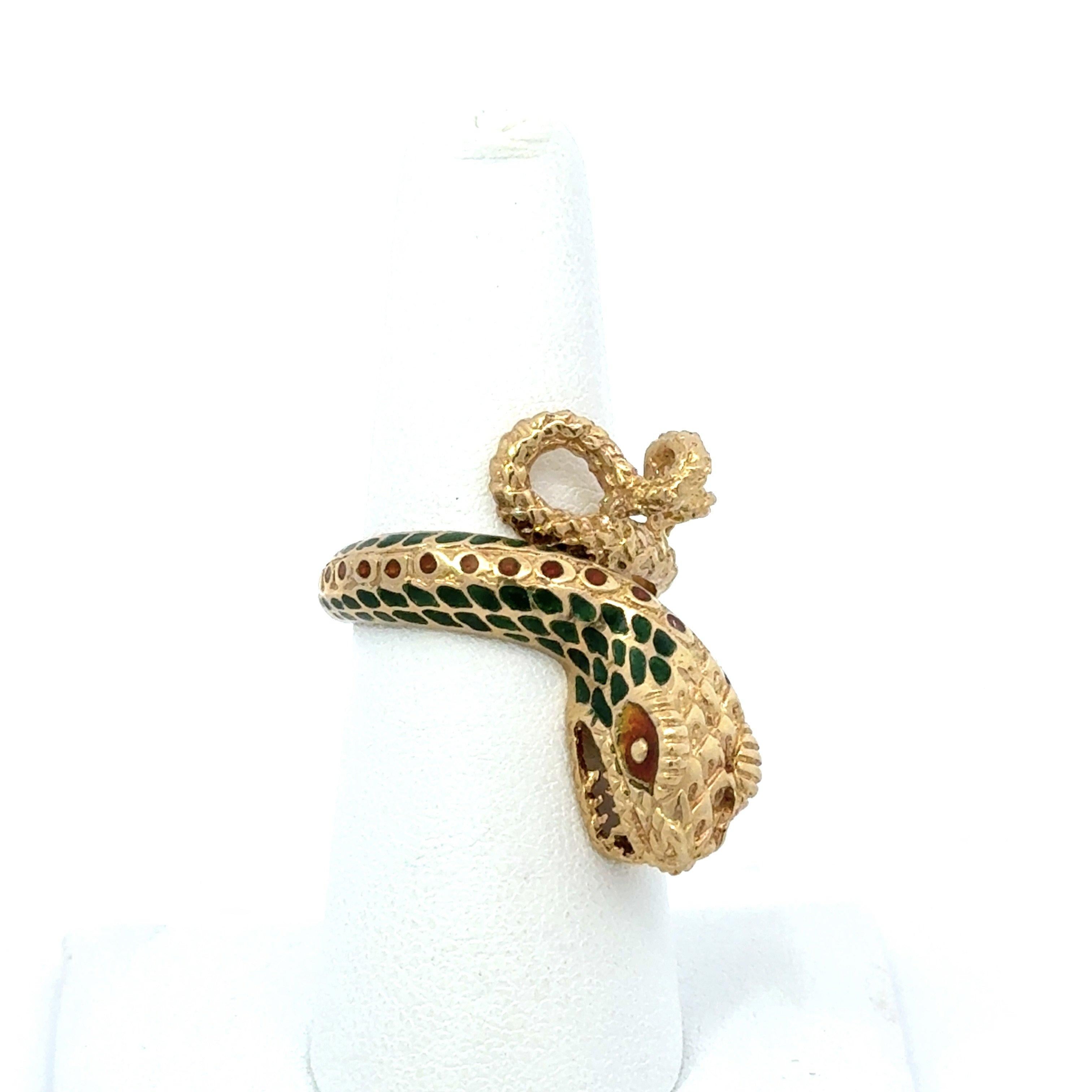 This vintage snake ring is crafted in 18KT yellow gold and dates from the 1950s.  It features green and orange enamel detailing. The ring measures 1 inch long from the tail to the head, and the shank tapers from 6mm to 3.2mm.  The ring is a size 7