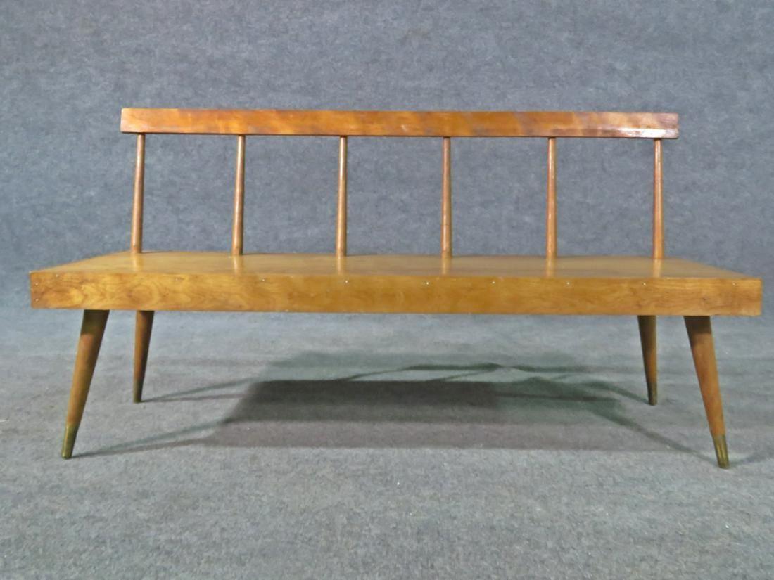 With a vibrant walnut wood grain, spindle back, and brass footing, this vintage Mid-Century Modern bench is sure to add timeless style to any space. 

Please confirm item location with seller (NY/NJ).