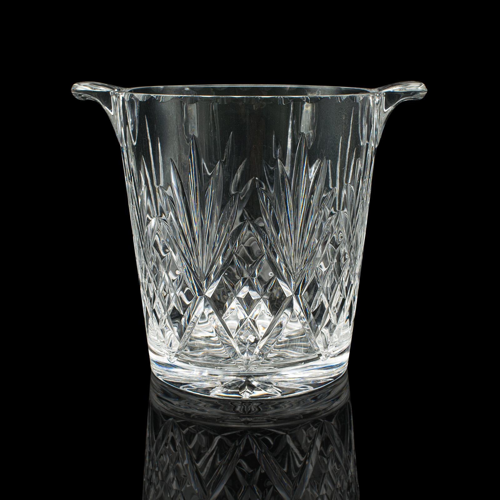 
This is a vintage wine cooler. An English, cut glass ice bucket, dating to the mid 20th century, circa 1960.

Appealing cut glass appearance, with a generously sized form
Displays a desirable aged patina and in good order
Quality cut glass presents