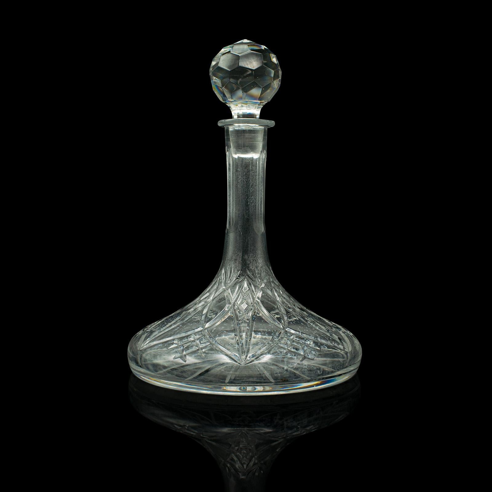 This is a vintage wine decanter. An English, cut glass decorative spirit vessel, dating to the early 20th century, circa 1930.

Striking form and patterns accentuate this appealing decanter
Displays a desirable aged patina and in good order
Quality