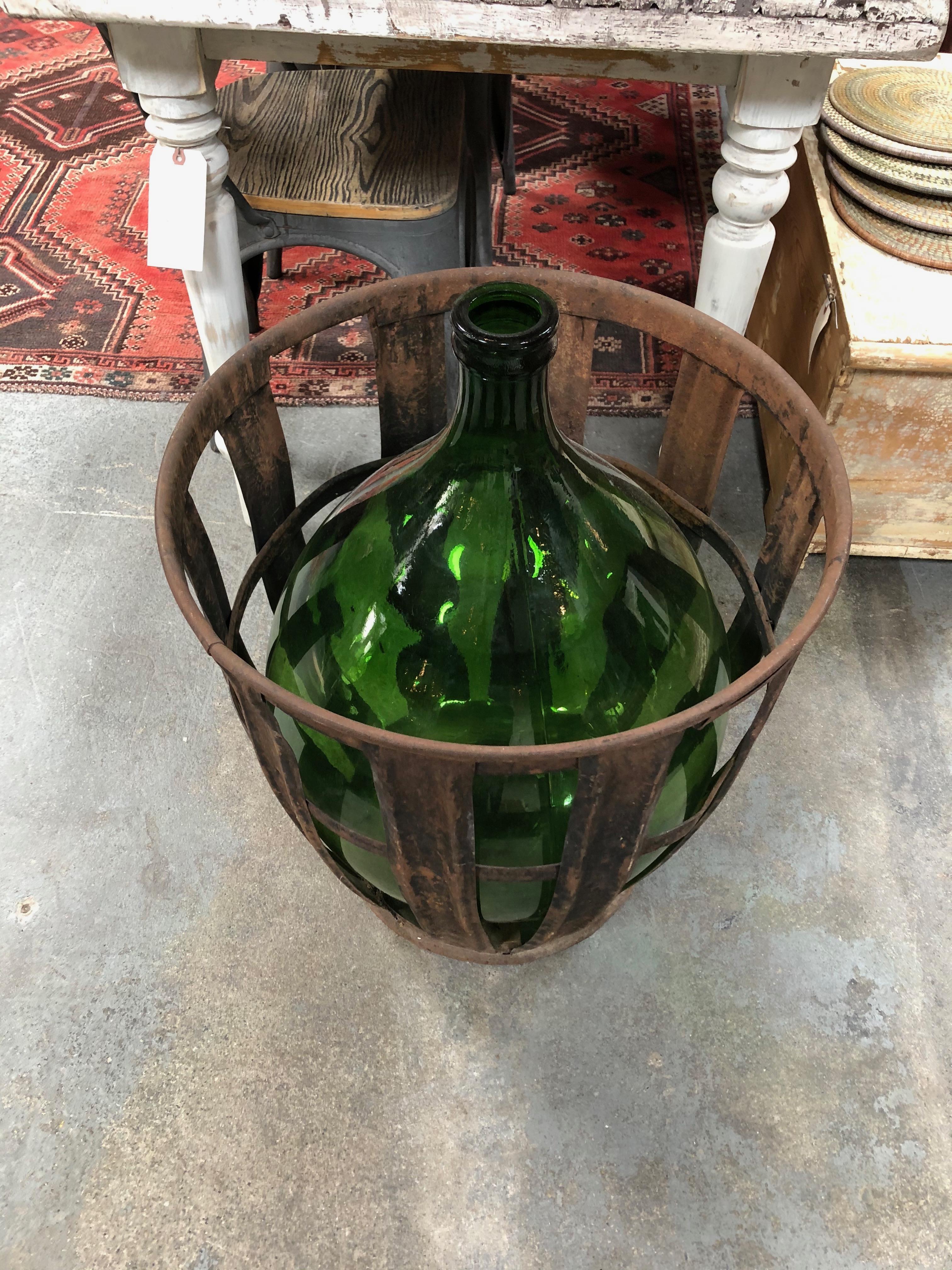 Gorgeous large green glass jug sits perfectly in the metal basket for a classic vintage style.