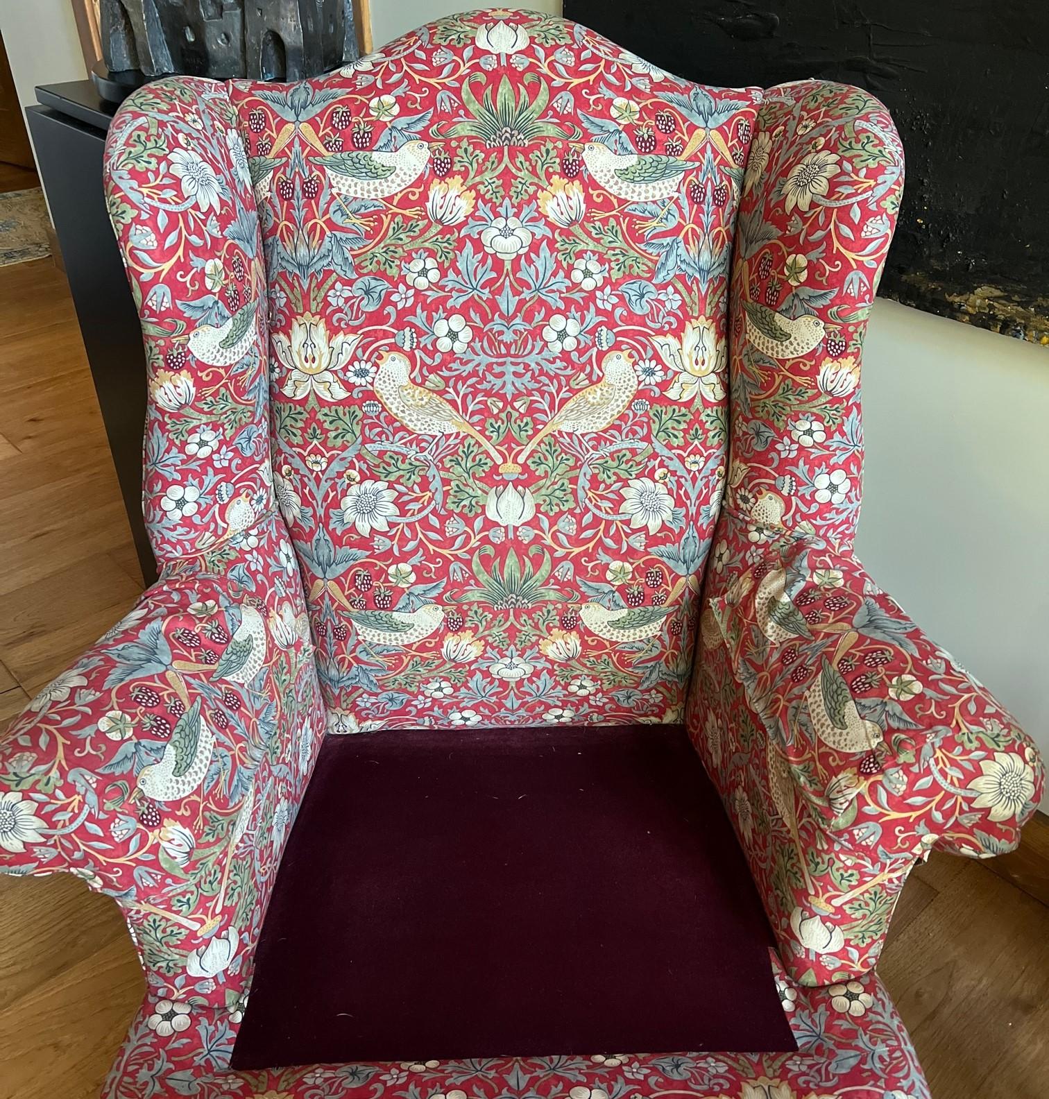 A vintage, roomy wingback armchair and ottoman reupholstered in the iconic 