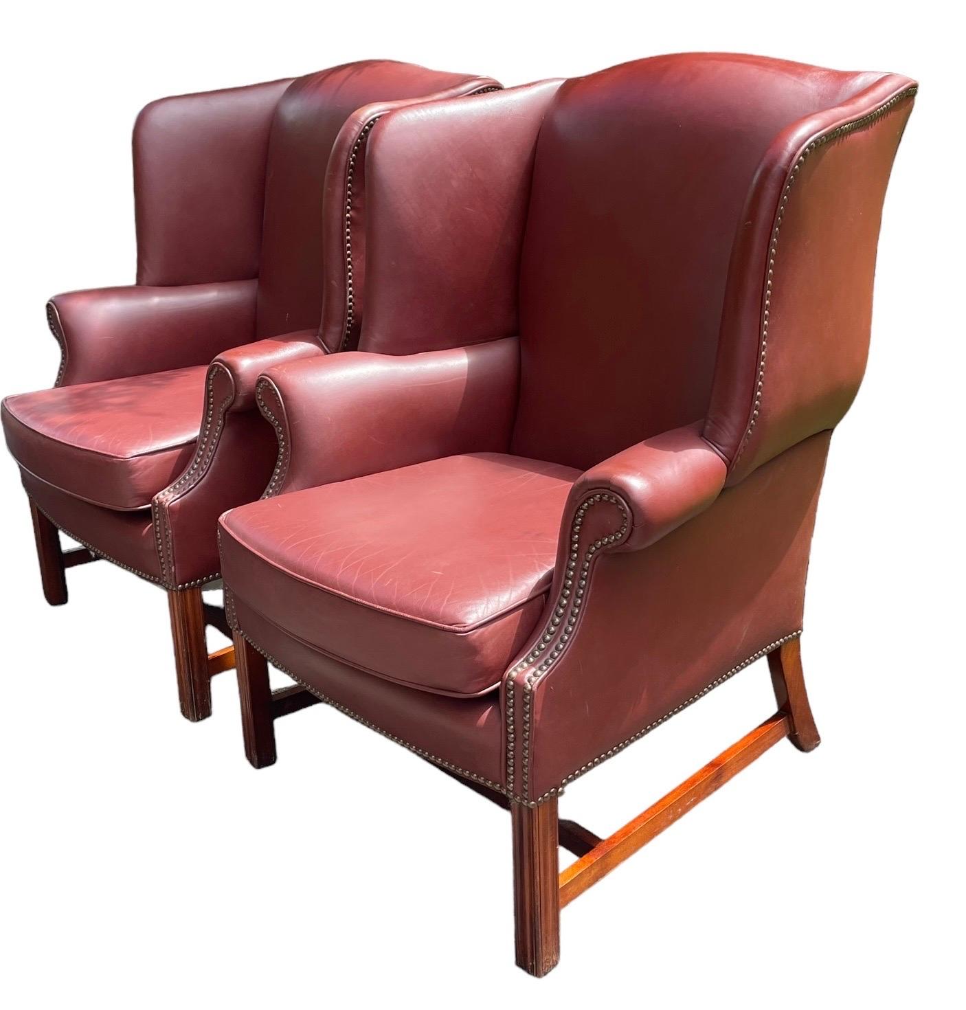 Gorgeous mint condition pair of wingback armchairs upholstered in red leather.

DIMENSIONS 

Armchair 32W x 26.5D x 40H
Seat Height 20”
Interior Width 22”
Interior Depth 21”

A fantastic vintage pair of leather wingback chairs to fit a multitude of