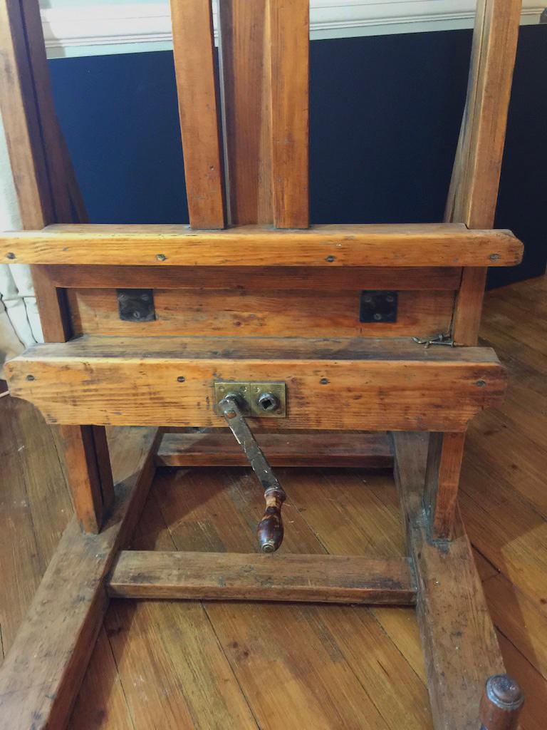 Very large Winsor and Newton pine studio easel - from a working artist's studio with two lifting mechanisms at the back. Well used and has lots of character. Minor repairs to header block.