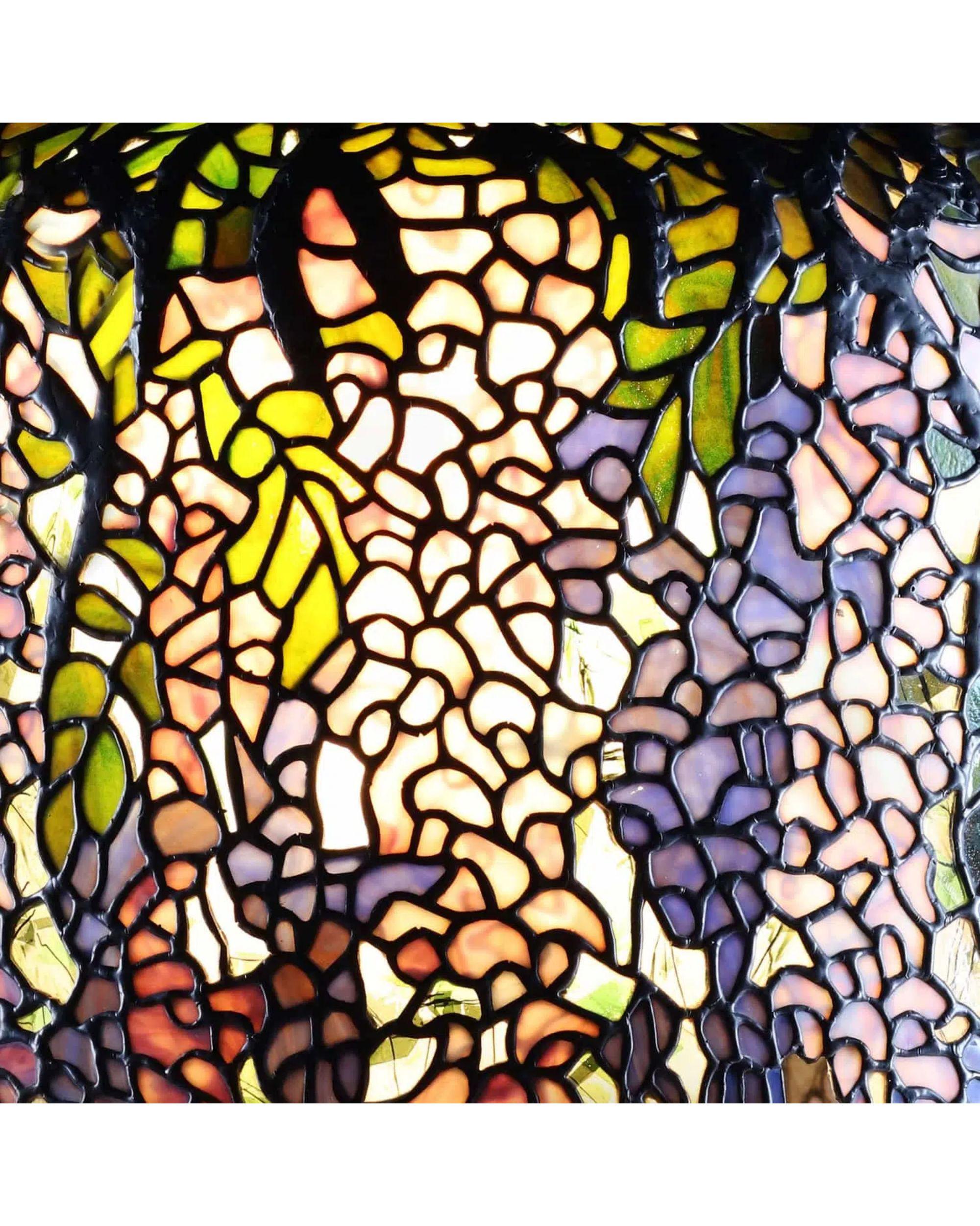 Wisteria’ Table Lamp after Tiffany Studio’s.

The Wisteria Large Tiffany Table Lamp is one of the most accomplished shade designs by Tiffany Studio’s. This extraordinary high-quality leaded glass shade comprises of almost 2000 individual pieces,