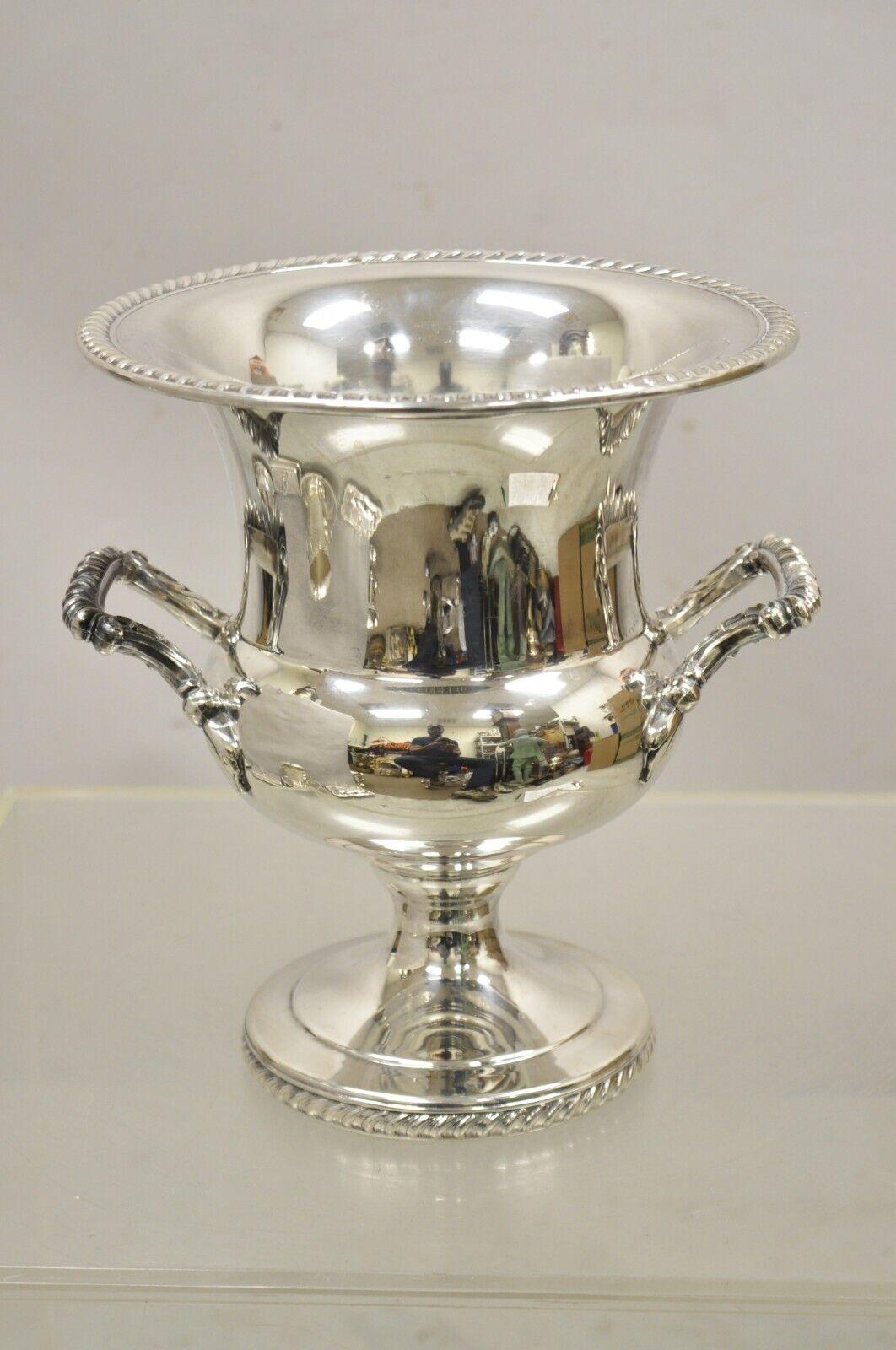 Vintage WM Rogers Regency Style Silver Plated Champagne Chiller Wince Ice Bucket. Item features raised pedestal base, ornate twin handles, original label, very nice vintage item,  great style and form. Circa Mid to Late 20th Century. Measurements:
