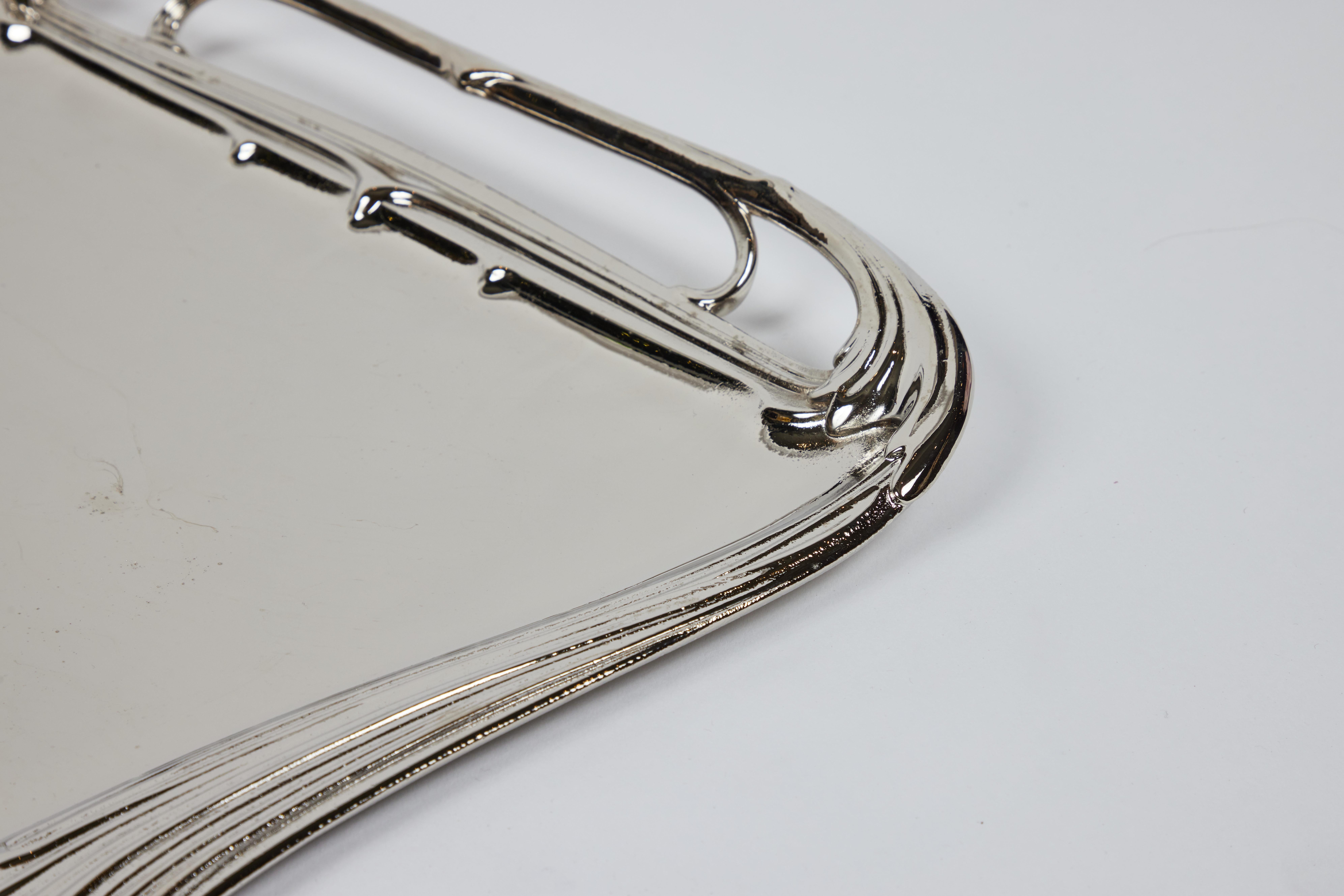 Our oversized vintage WMF serving tray is in an Art Nouveau style design. Simple yet so chic with beautiful curves and waves. It is heavyweight stainless and has been newly polished with a new nickel finish. A gorgeous statement wherever it is