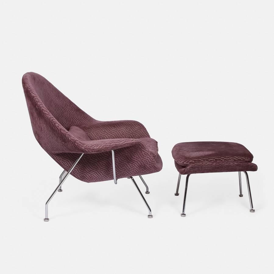 An Eero Saarinen womb chair and matching ottoman, raised on polished chrome supports with steering pad feet. 

Saarinen was given the following brief by Florence Knoll: 