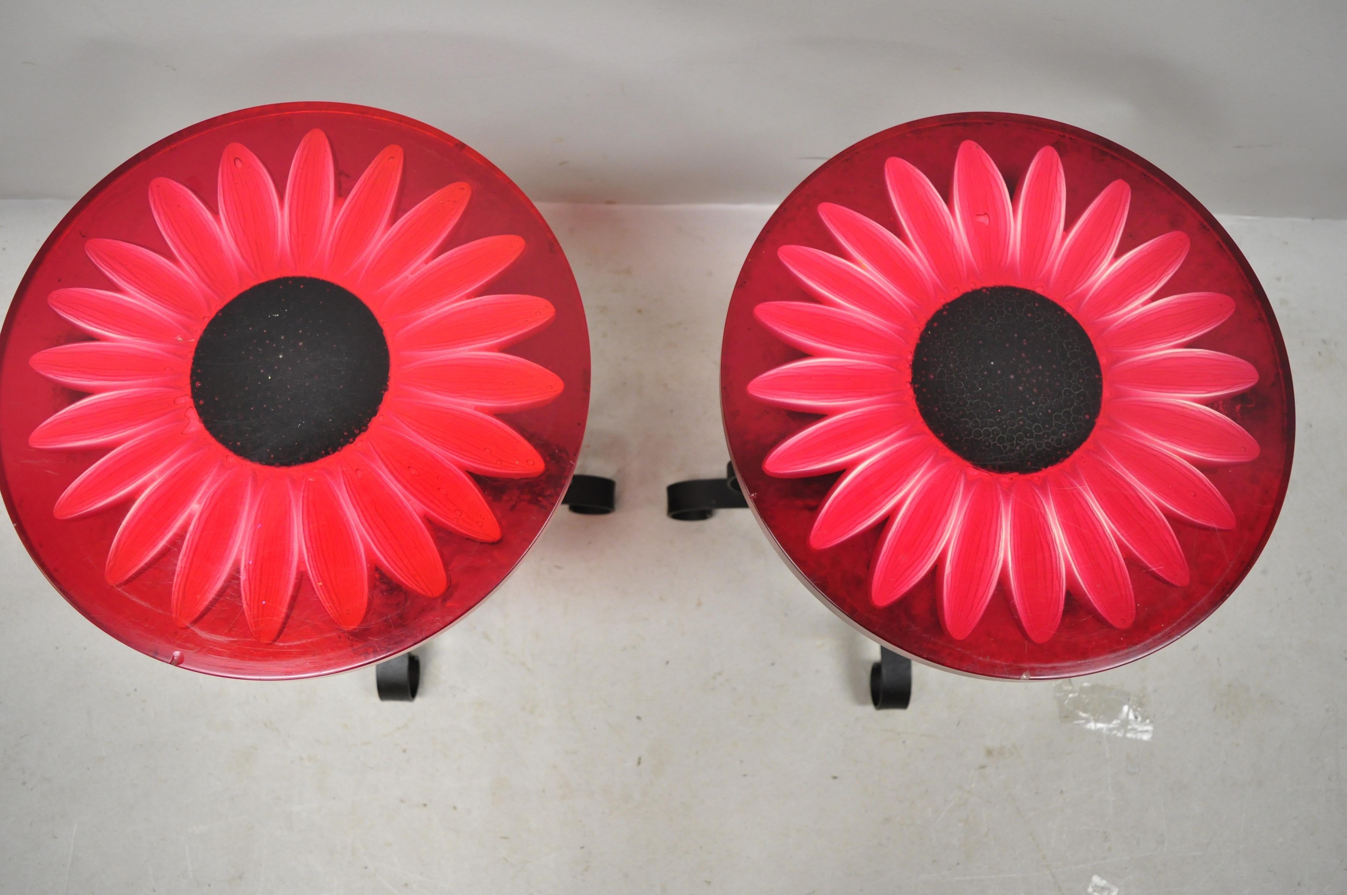 Vintage Wondermold Gamma Associates red resin sun flower iron side tables, pair. Item features red resin tops with encased flowers, wrought iron base, very nice vintage set, great style and form, circa mid-20th century. Measurements: 18.5