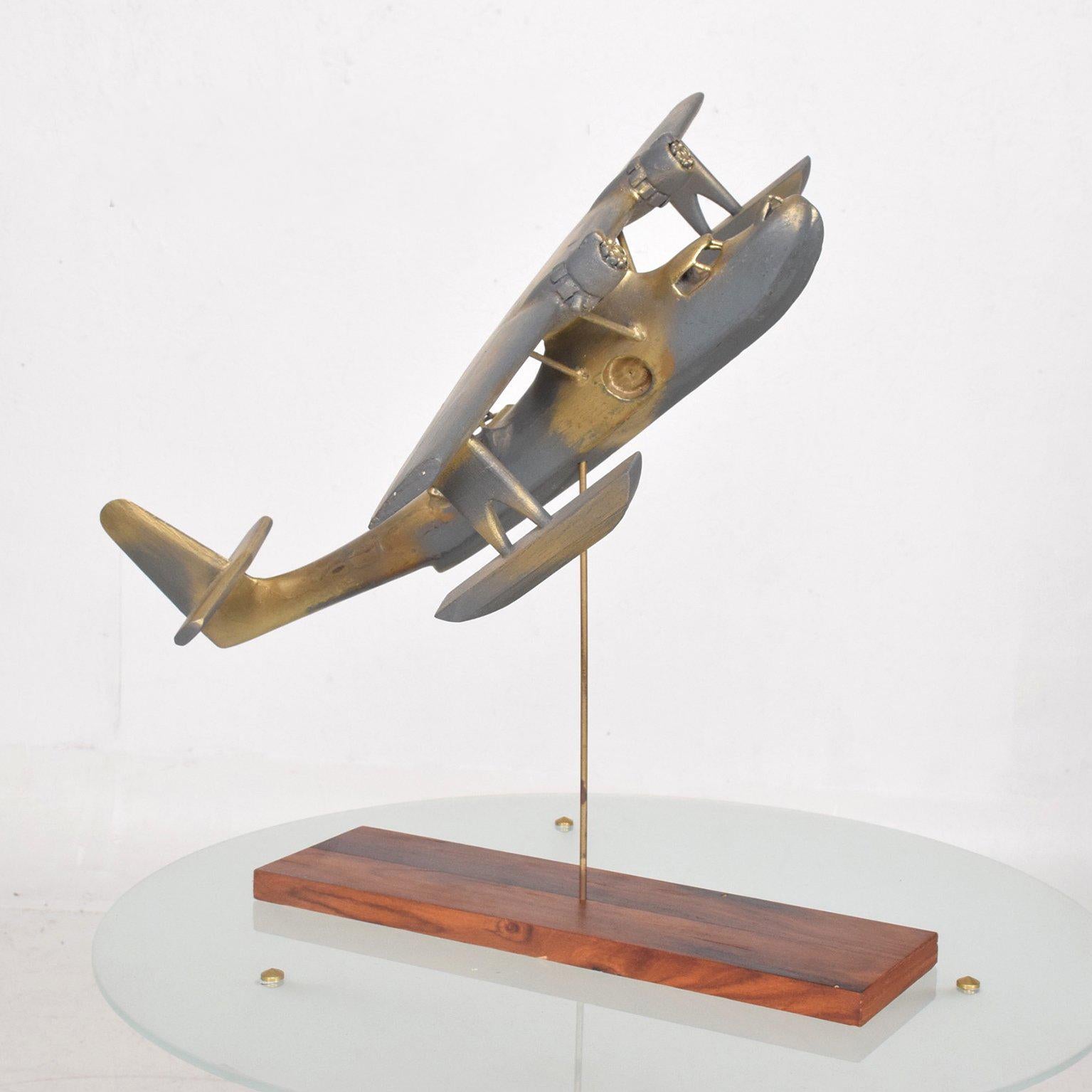 For your consideration a vintage wood airplane sculpture mounted in brass rod with rosewood base. 


WWII era. Great faux patina. 

Measures: 18 3/8