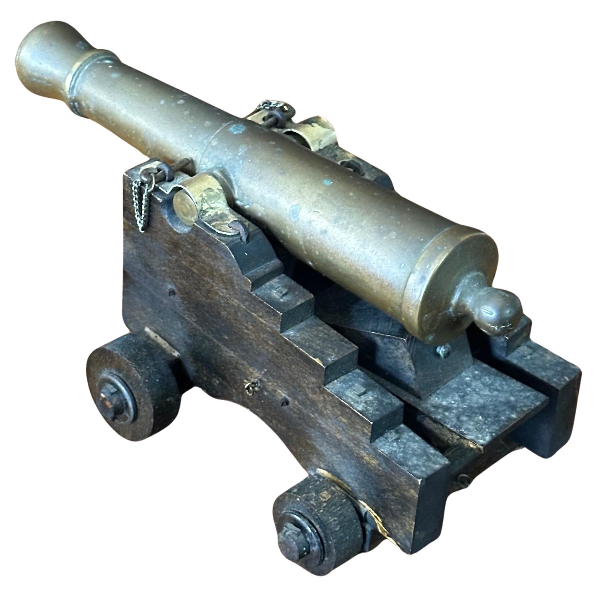 A very well made vintage wood and bronze cannon model, circa 1970s. The piece is in good condition with nice detailing and measures 4.5