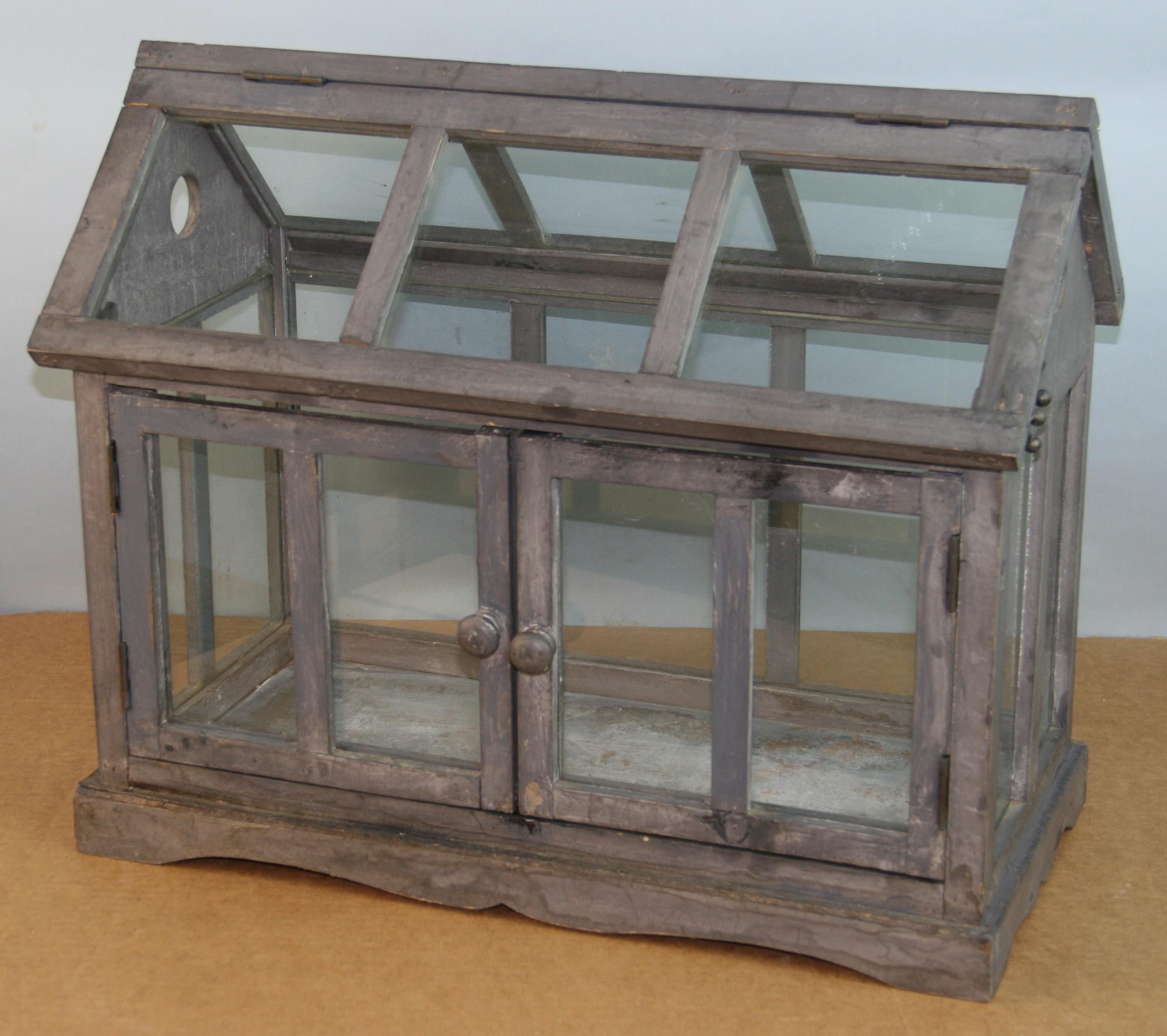 3-943 Hand made wood and glass terrarium / model green house with galvanized metal base.
Operable front door and hinged movable glass top with latch closure.