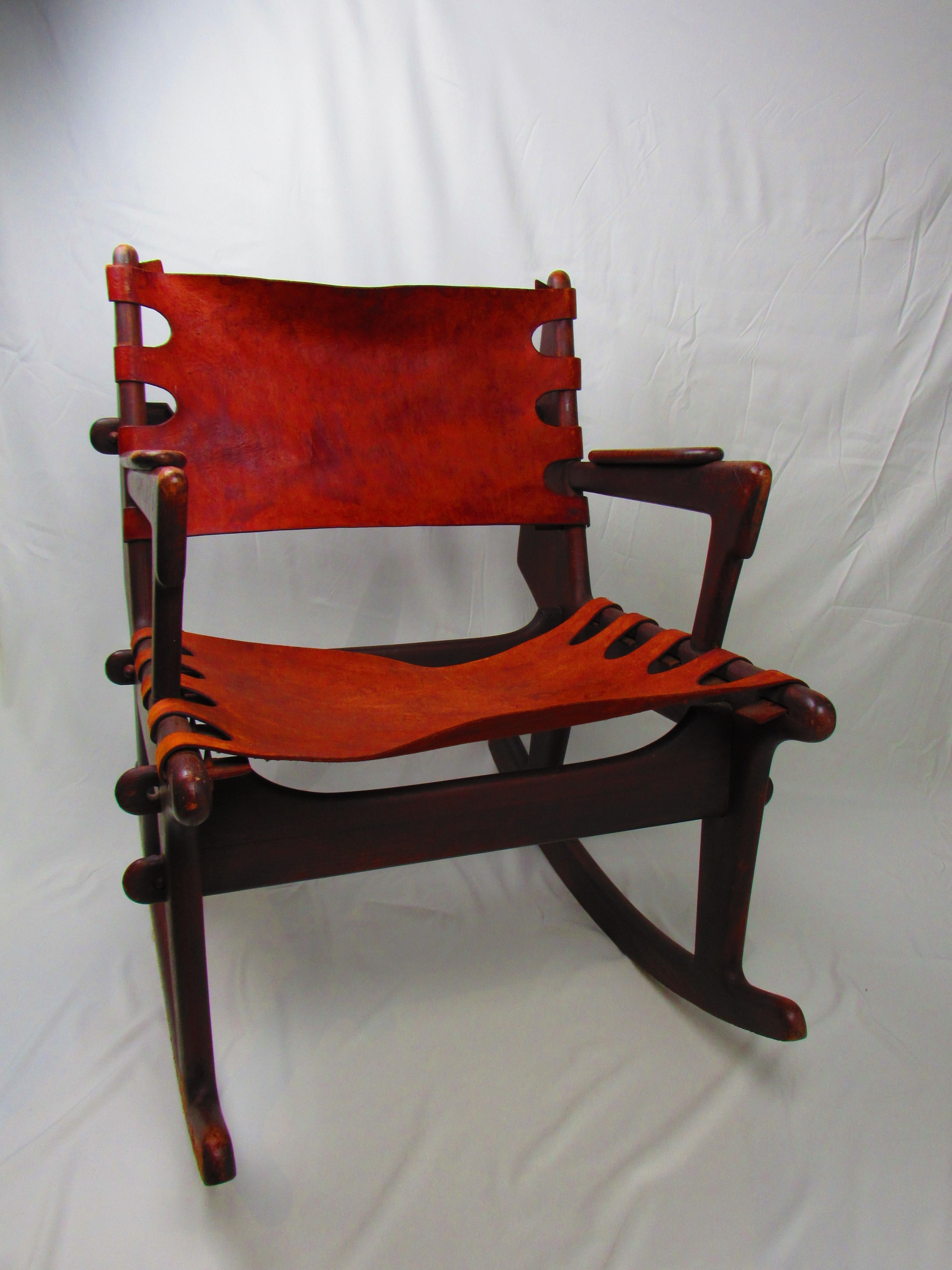 Add a touch of sophistication to your home with this vintage Angel Pazmino rocking chair, a masterpiece that blends classic elegance with artisanal craftsmanship. Designed by the renowned Pazmino, this vintage chair features a dark wood frame paired