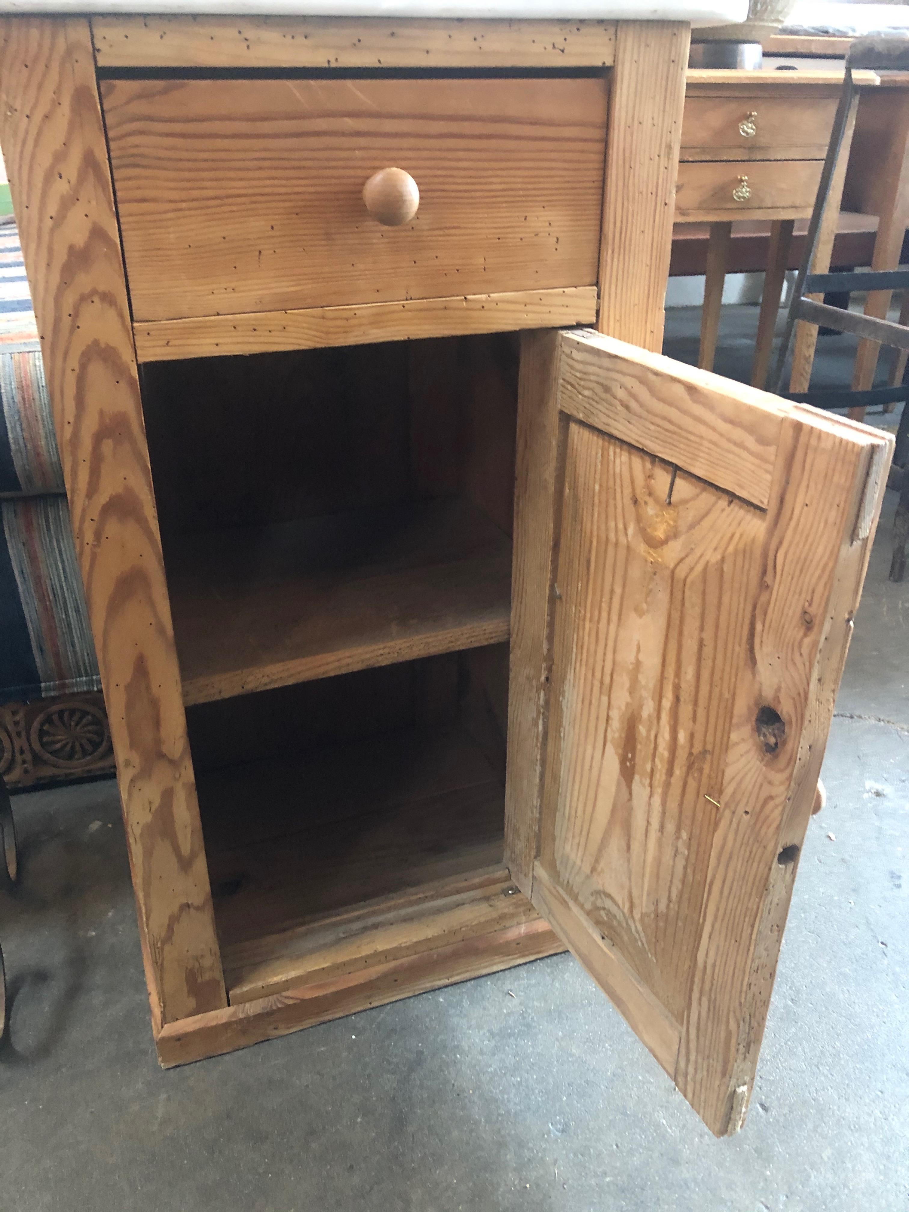 Rustic side table with white marble top. Small slide out drawer on top, and storage cabinet on the bottom. Natural wood unchanged from age. Would be great in a kitchen, bathroom, bedroom, living room, or office/retail space.
  