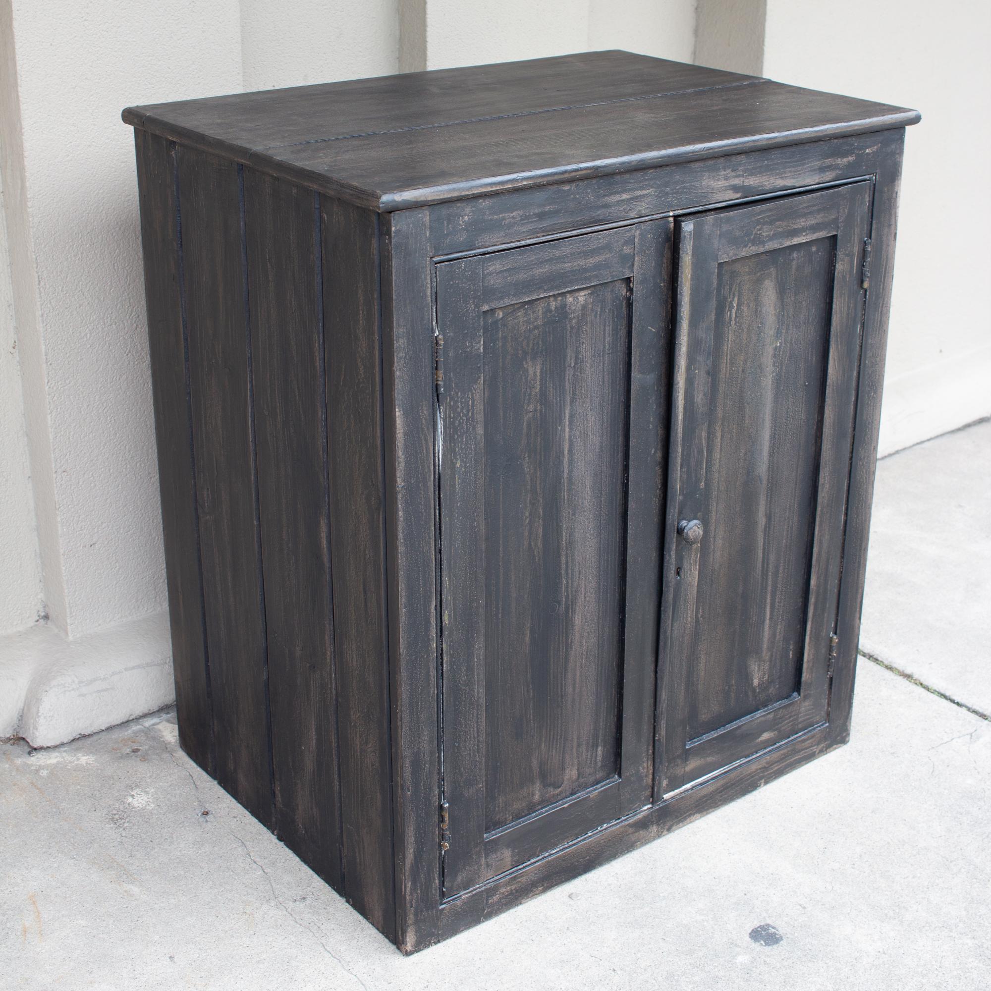 This vintage wooden cabinet features two front doors and an interior shelf with plenty of space for storage. The height is perfect to set this pieces up as a bar, or use for additional counter space as a small cabinet in a kitchen or pantry area.