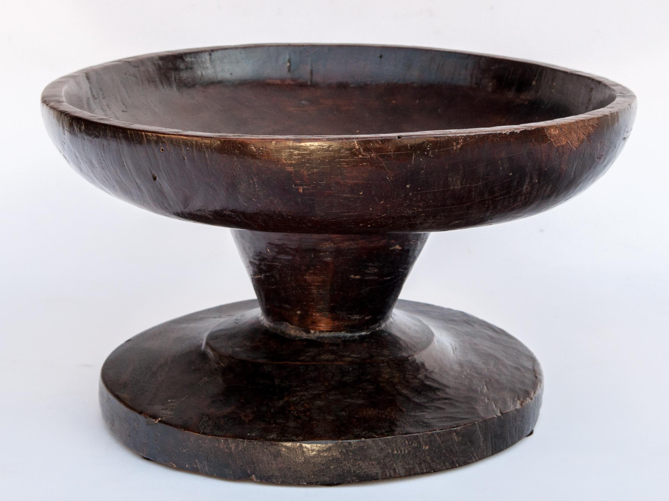 Vintage wooden bowl on stand from Sulawesi, Indonesia, mid-20th century.
This wooden bowl from the mountains of Sulawesi was fashioned by hand from local hardwood. The shape and deep cupped bowl are typical of the style from this area, but this
