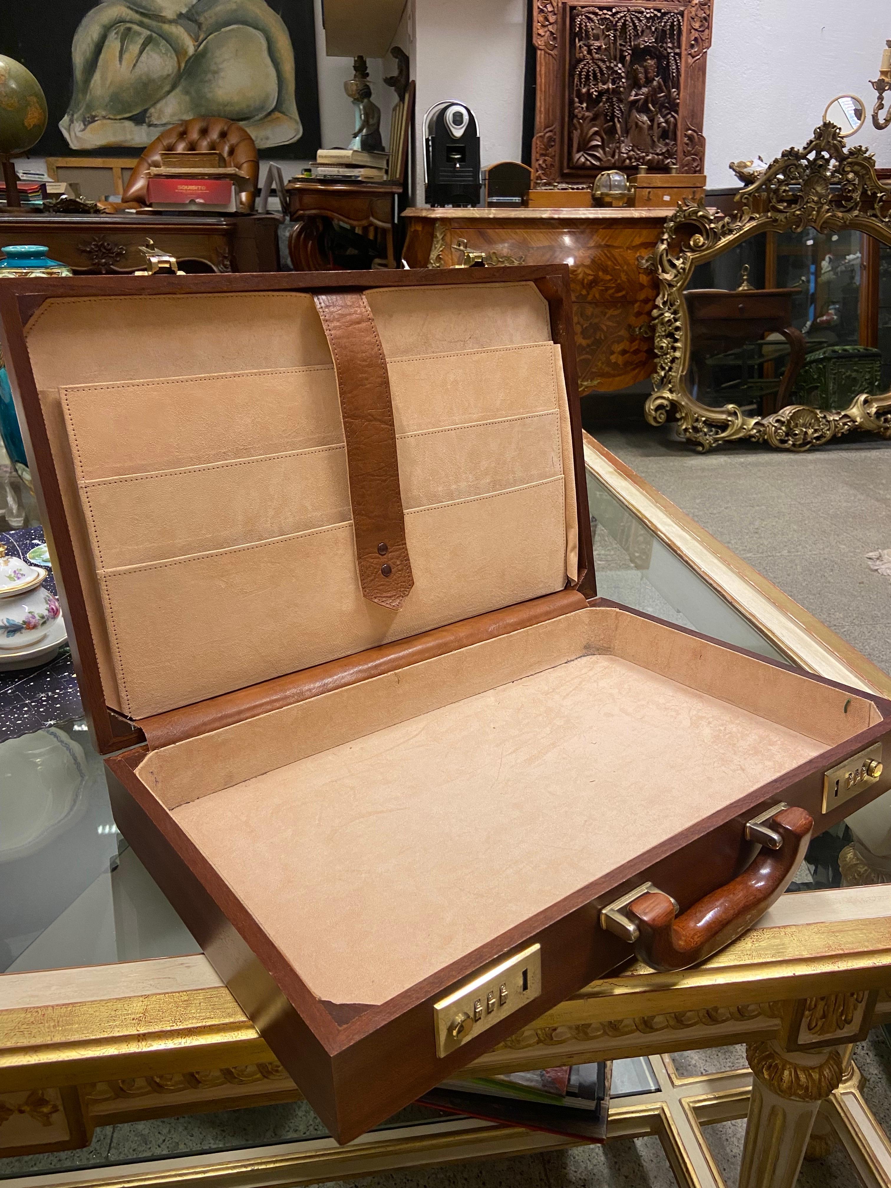 Elegant vintage briefcase constructed from several woods, burr walnut veneer, with combination locks and wooden handle, the interior with light beige suede lining and pockets with brown leather trim, the case measuring 60 x 40 x 7 cm overall. Very