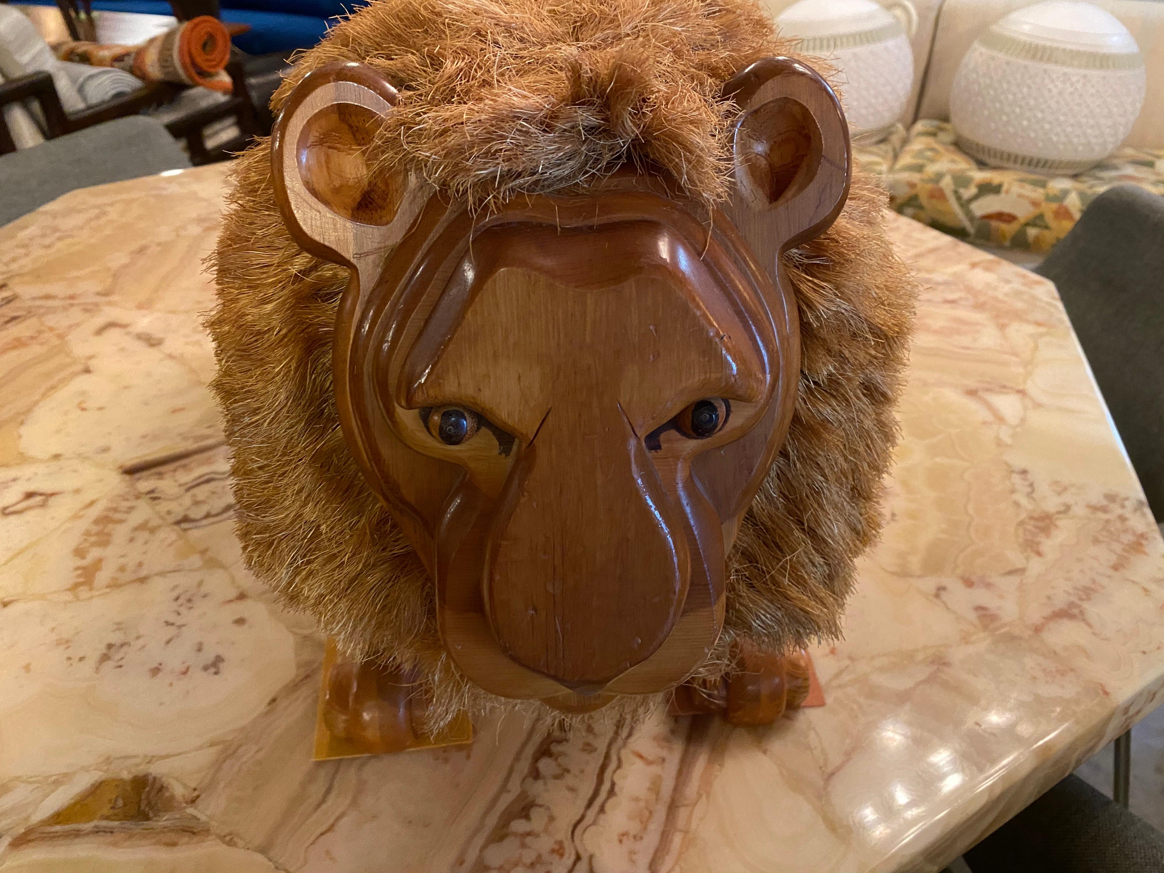Adorable vintage wood carved lion footstool. The tail and mane are made of a rough-textured bristle. Great for a child's room or just to have as a unique piece in any space. This vintage footstool is in good overall condition.