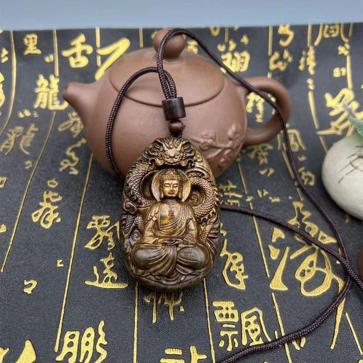 This Vintage Wood Carving Sitting Buddha With a Dragon Statue Pendent from China is a unique and powerful representation that combines elements of Buddhist and traditional Chinese symbolism. 

The sitting posture signifies meditation, inner peace,