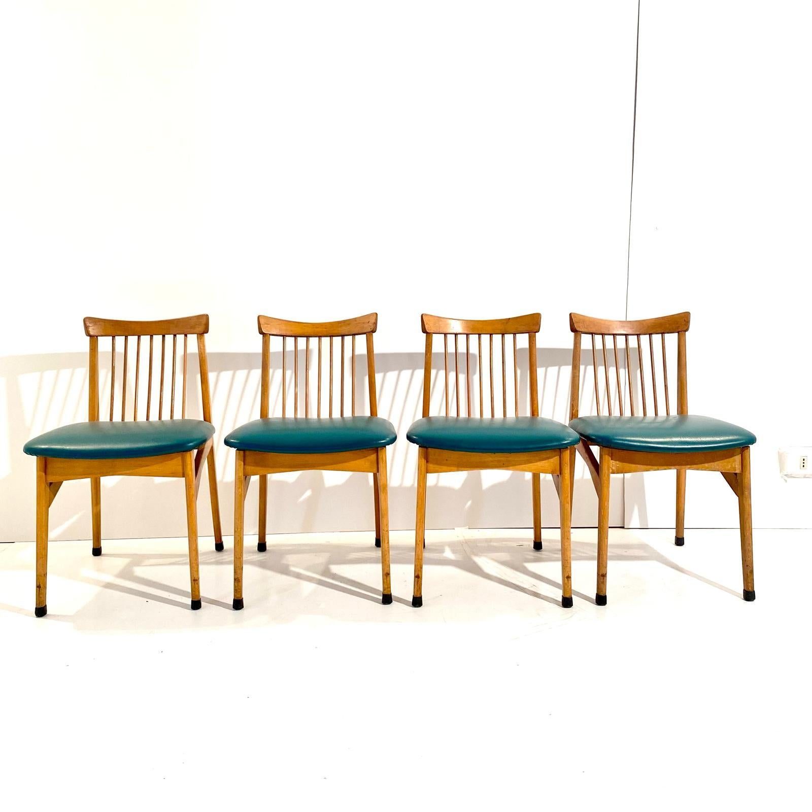 Vintage wood dining chairs, set of four, Italy 1960s.
Set of four solid beech wood structure with beautiful back seat. Sturdy solid wood structure and original green faux leather. Manufactured in Italy in the 1960s. 

Wood has been traited and