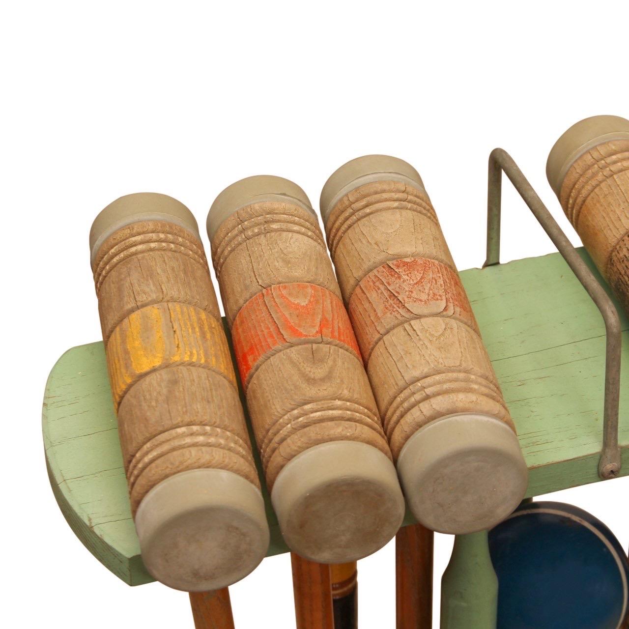 Ein Vintage-Krocket-Set.

USA, ca. 1920-1940.

Enthält Holzschläger, Holzkugeln und Metalltore in einem rustikalen grünen Ständer mit Rädern. 

Originalfarbe.  
