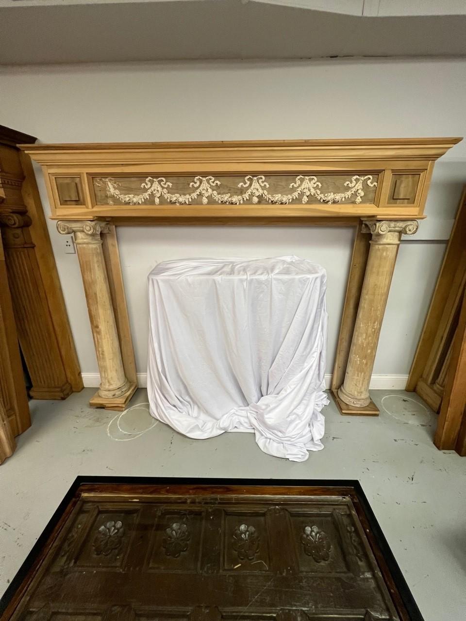 Vintage antique wood fireplace mantel with round columns and a beautiful face with draped ribbons and flowers. This is a very nice mantel with the full columns raise panels and decorative face that would be a great focal point in any room of your