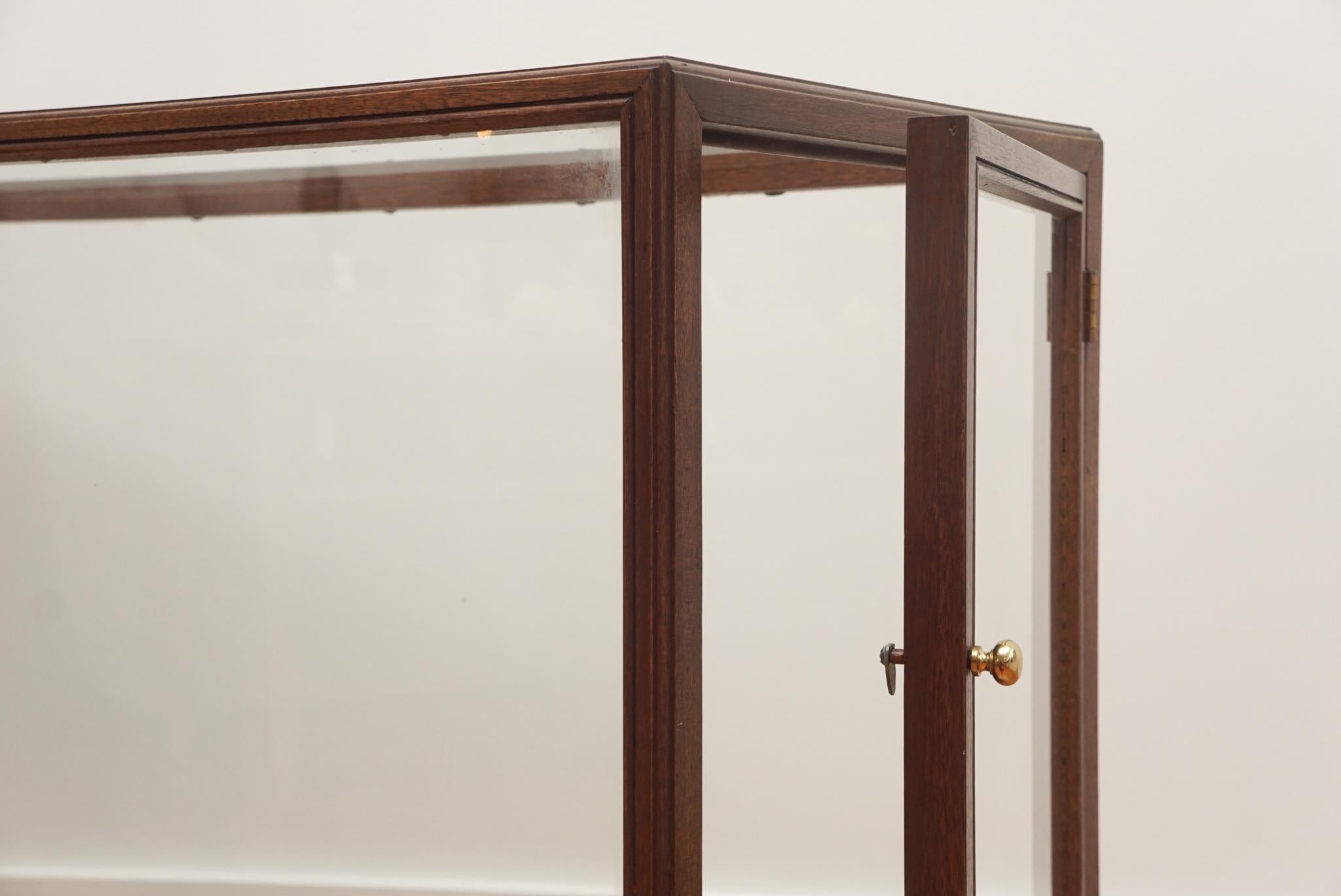 glass showcase with wooden frame