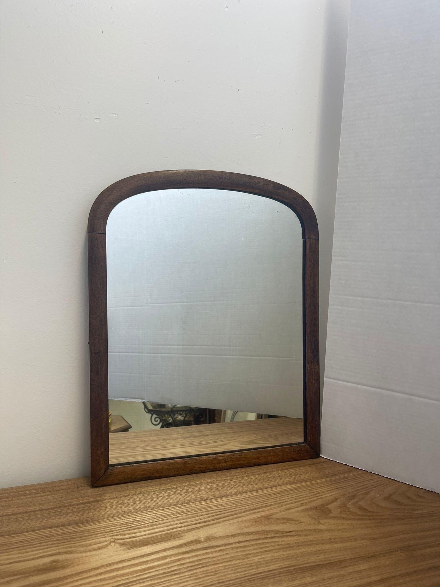 This Arched Wall Mirror toned with original hardware. Slight patina to the glass shows age. Vintage Condition Consistent with Age as Pictured.

Dimensions. 15 1/2 W ; 1 D ; 20 H