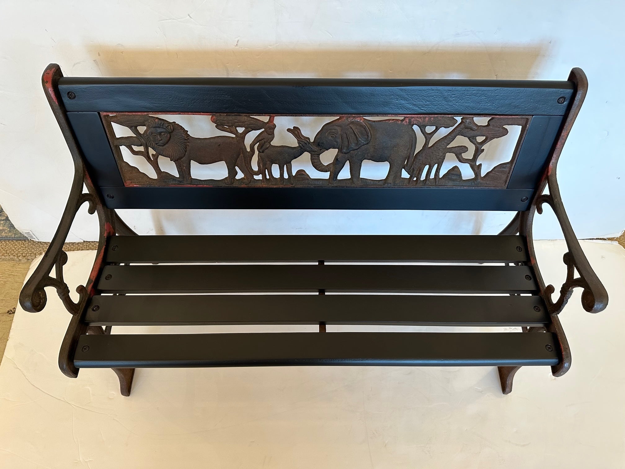 Delightful child size iron and wood bench having a Noah's ark of animals adorning it.
All wood is new and painted with automotive paint so it can be outdoors. 
