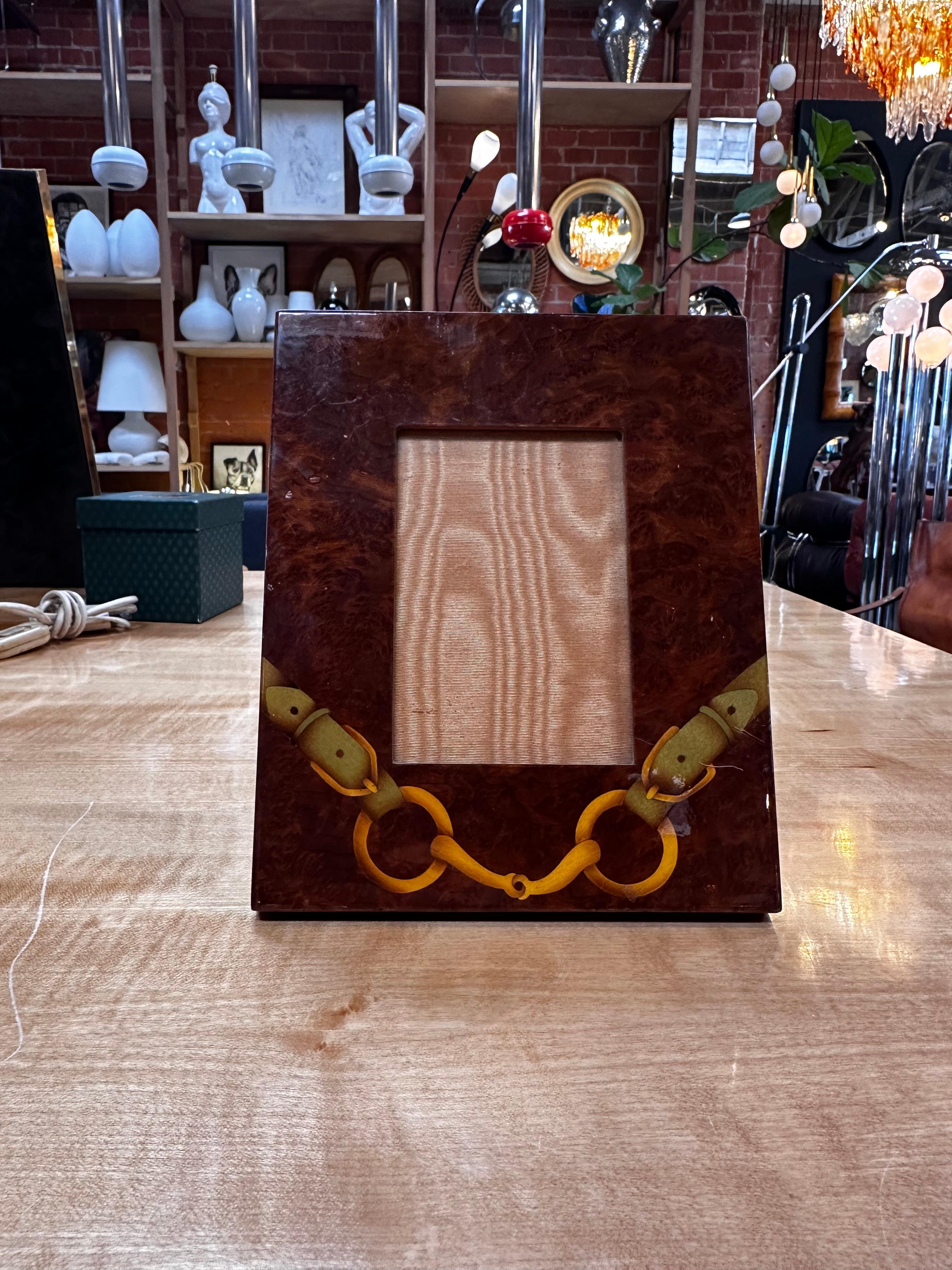The Vintage Wood Italian Picture Frame by Gucci is a sophisticated and luxurious piece of decor. Crafted in Italy, this frame is made from wood, showcasing both elegance and quality. The fact that it is signed by Gucci adds a touch of prestige and