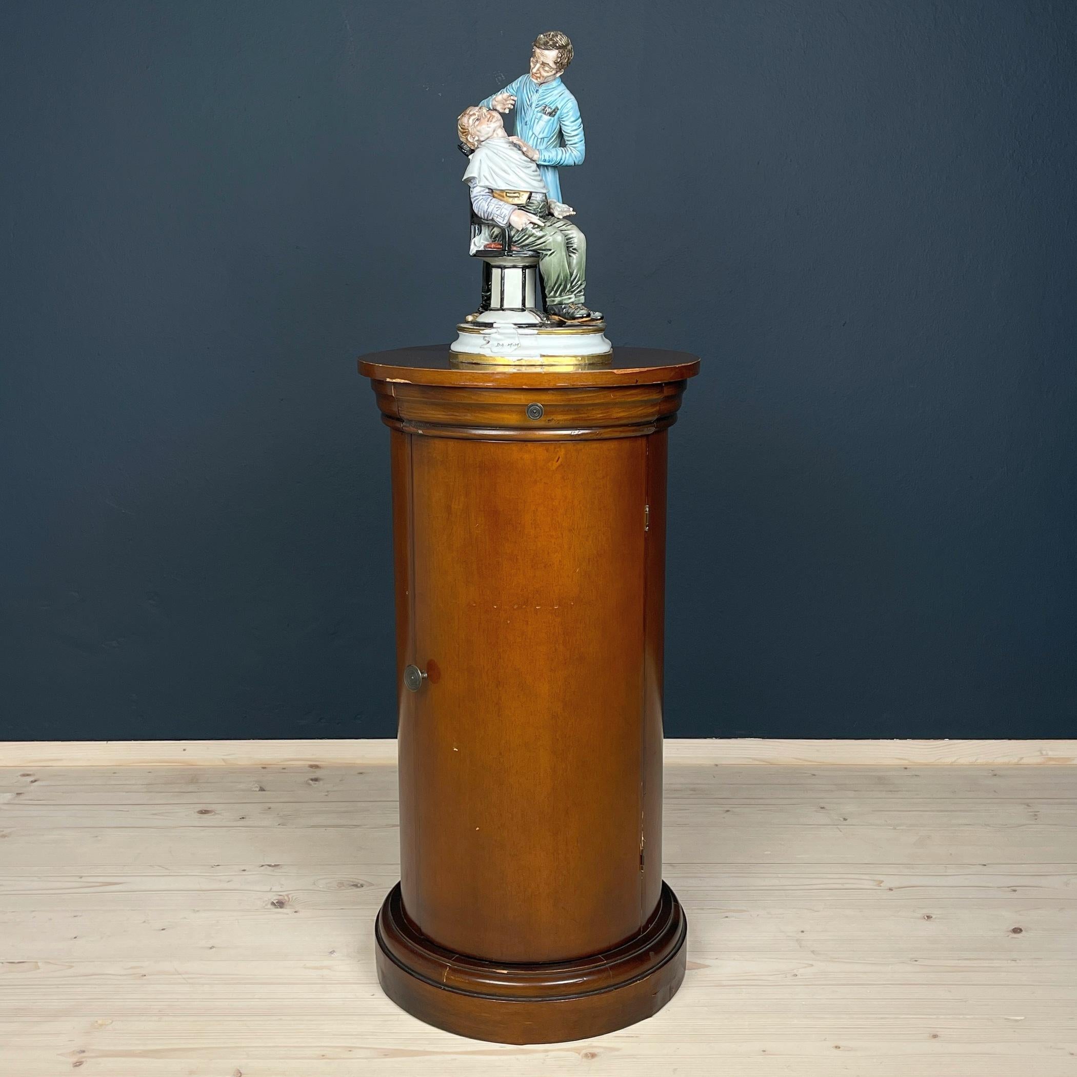 This exquisite oval pedestal cabinet hails from 1970s Italy, showcasing meticulous craftsmanship. Constructed from solid wood and plywood, it boasts original fittings that add to its authenticity and charm. Remarkably, this pedestal cabinet has