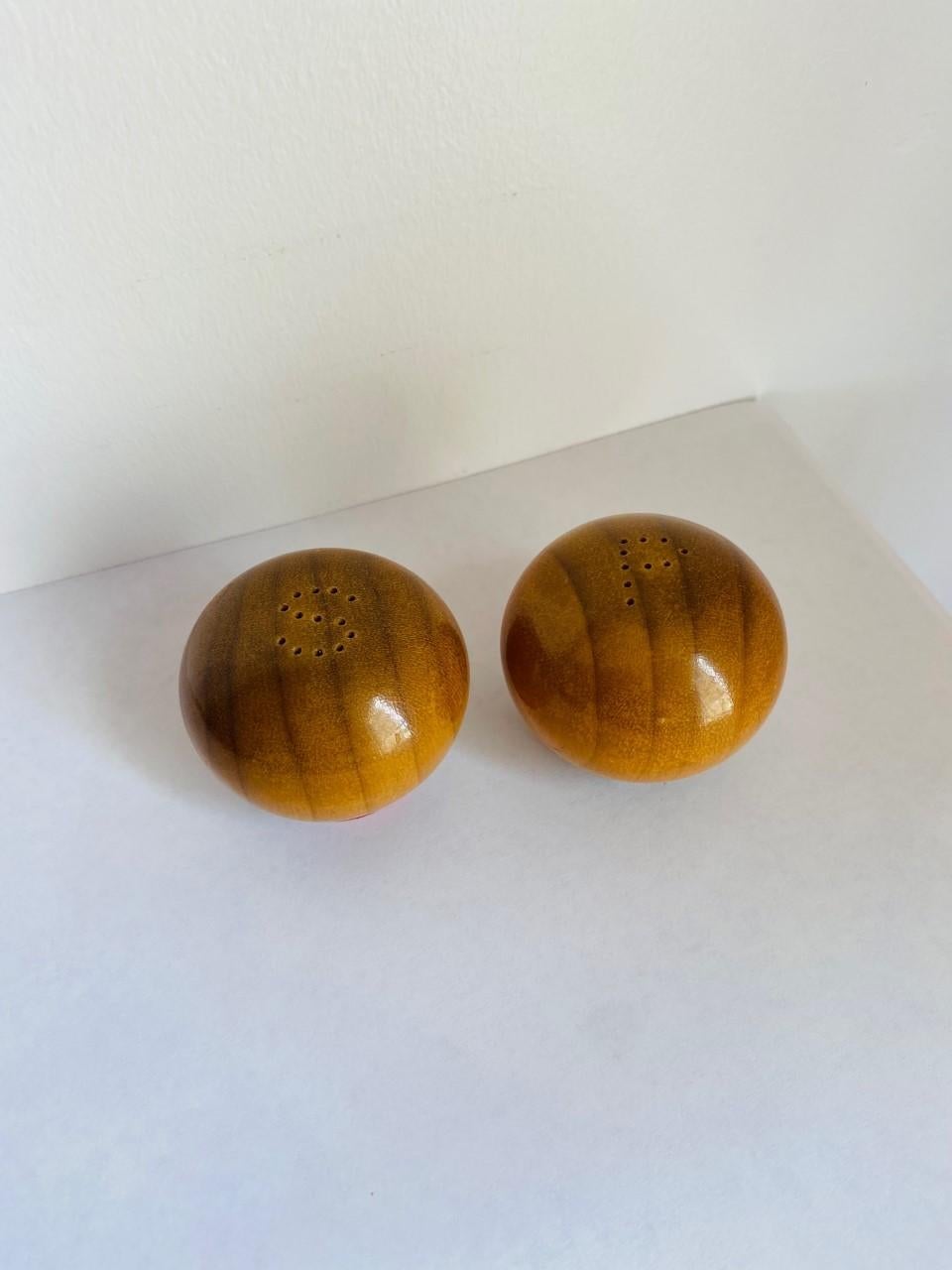 Beautiful and unique set of salt and pepper shakers. This pair is handmade in polished finished wood that shows beautiful grain. Each piece has fine details such as the 