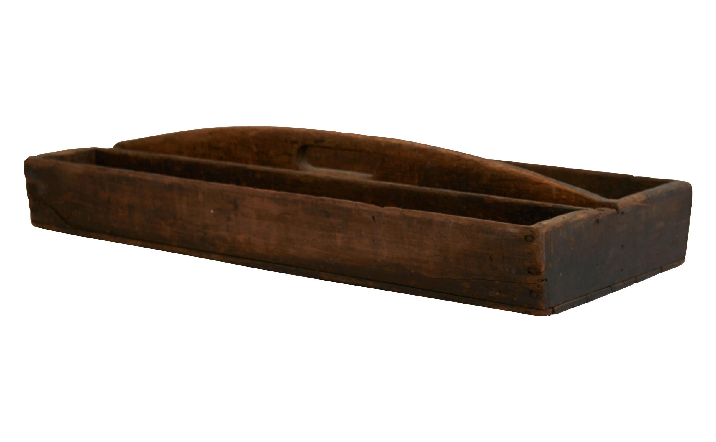 Our vintage wood caddy was made in America in the mid-20th century. Handcrafted from wood, it features a carrying handle and an attached divider on one side. Sturdy and still functional, it is in good rustic condition with scratches and marks