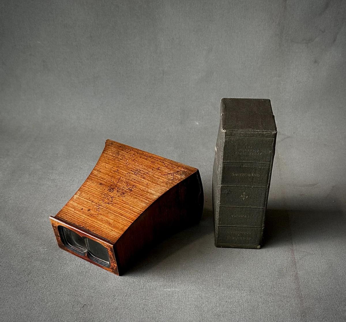 This late 19th-century English stereoscope viewer, crafted from richly hued wood, offers a charming glimpse into Victorian visual entertainment. Included are sepia-toned viewing cards depicting the serene landscapes of the Swiss Alps, allowing for