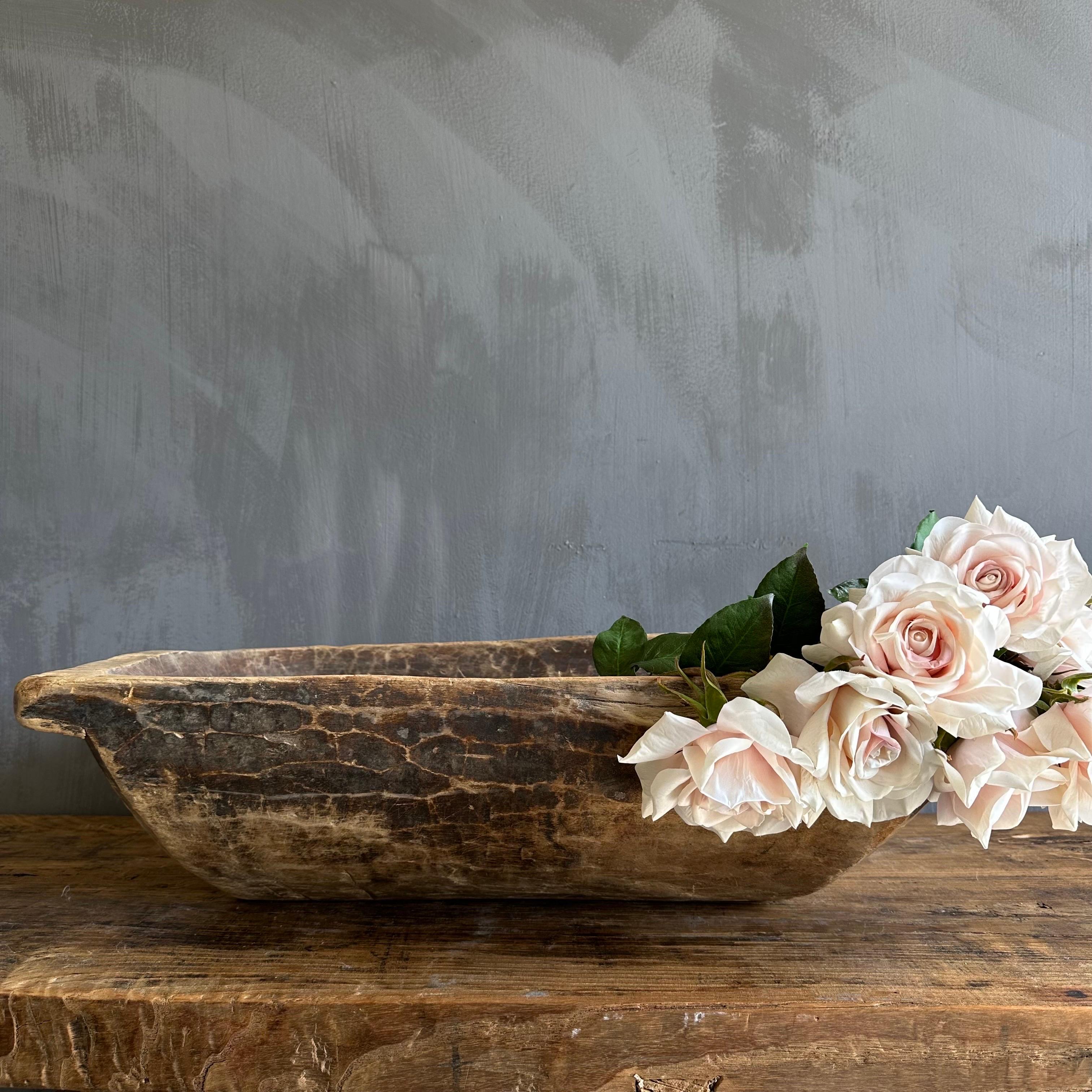 Vintage wood trough decorative bowl
 Beautiful wood trough with natural patina. Can be used on a dining table or server for decoration.
Wood is natural with patina. Some troughs will have decorative metal on or around the bowl, please view the