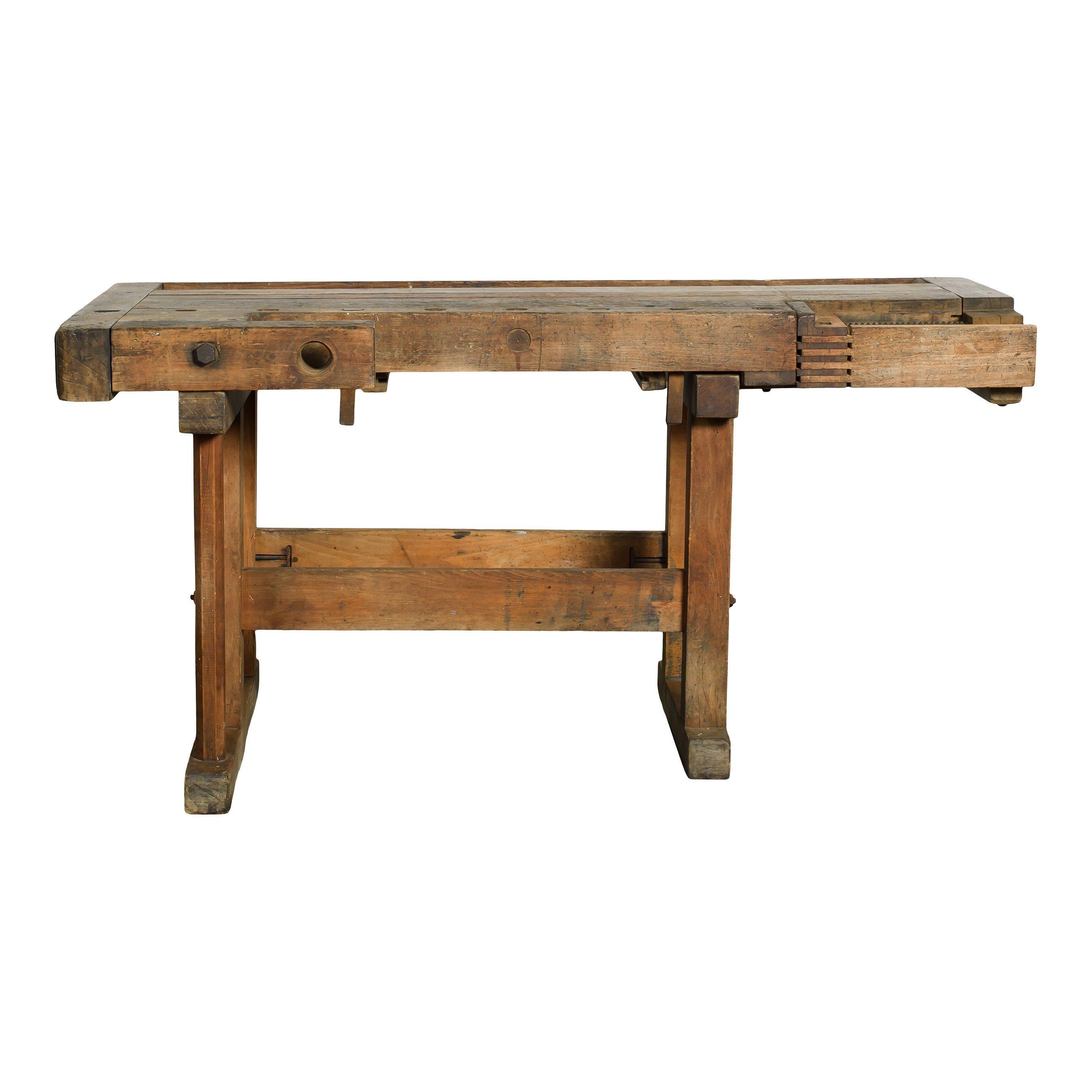 A lovely vintage wood workbench with perfect details and vintage patina. The tabletop is thick and sturdy and features built-in screw clamps and dovetail joints, beautiful details classic of the time and functionality. The legs are also sturdy and