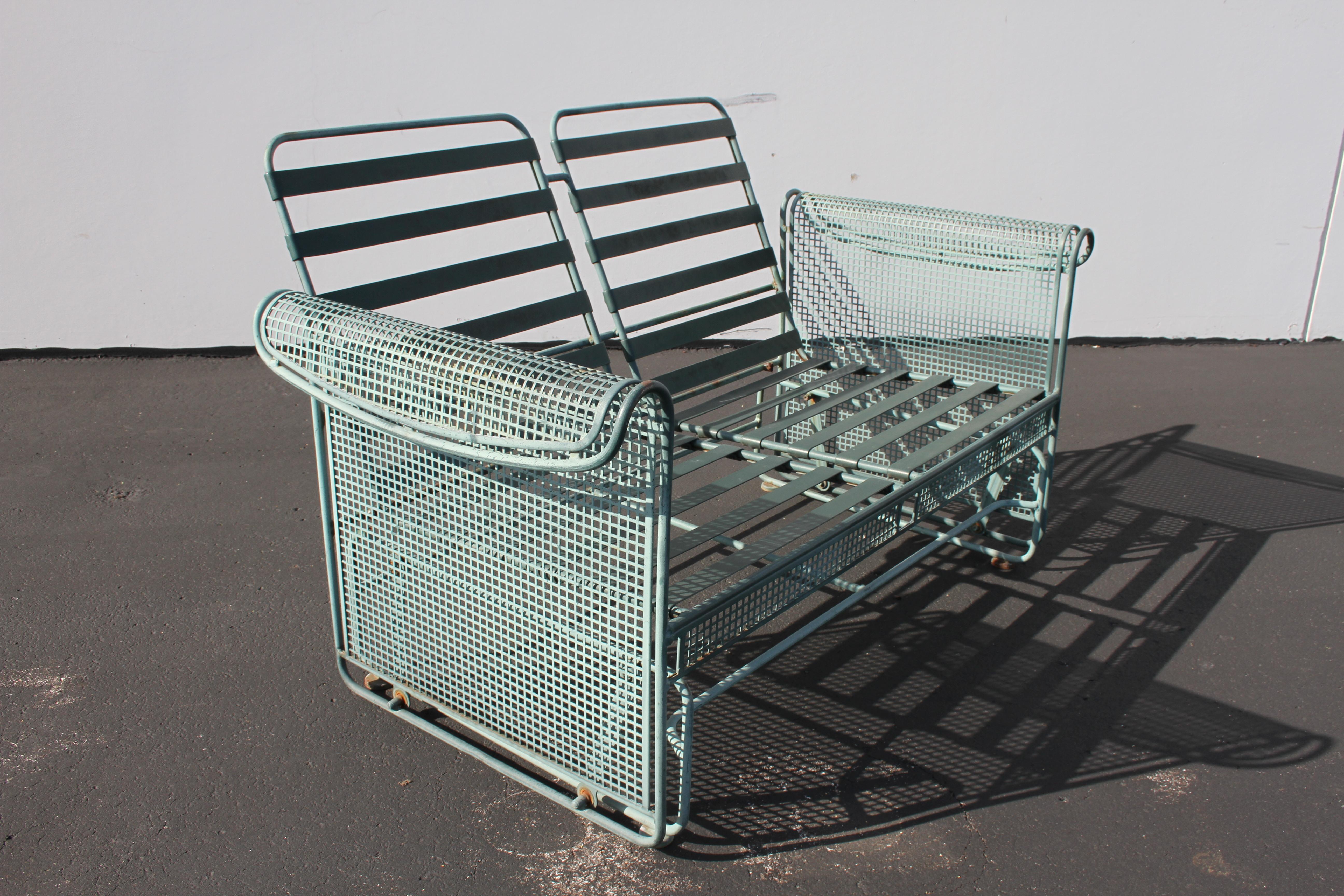 Vintage Woodard patio set with both rocking glider-settee and armchair, coffee table and side table. Shown with faded original green paint and grid / mesh pattern sides reminiscent of the metal work of architect Josef Hoffmann for Wiener Werkstätte.