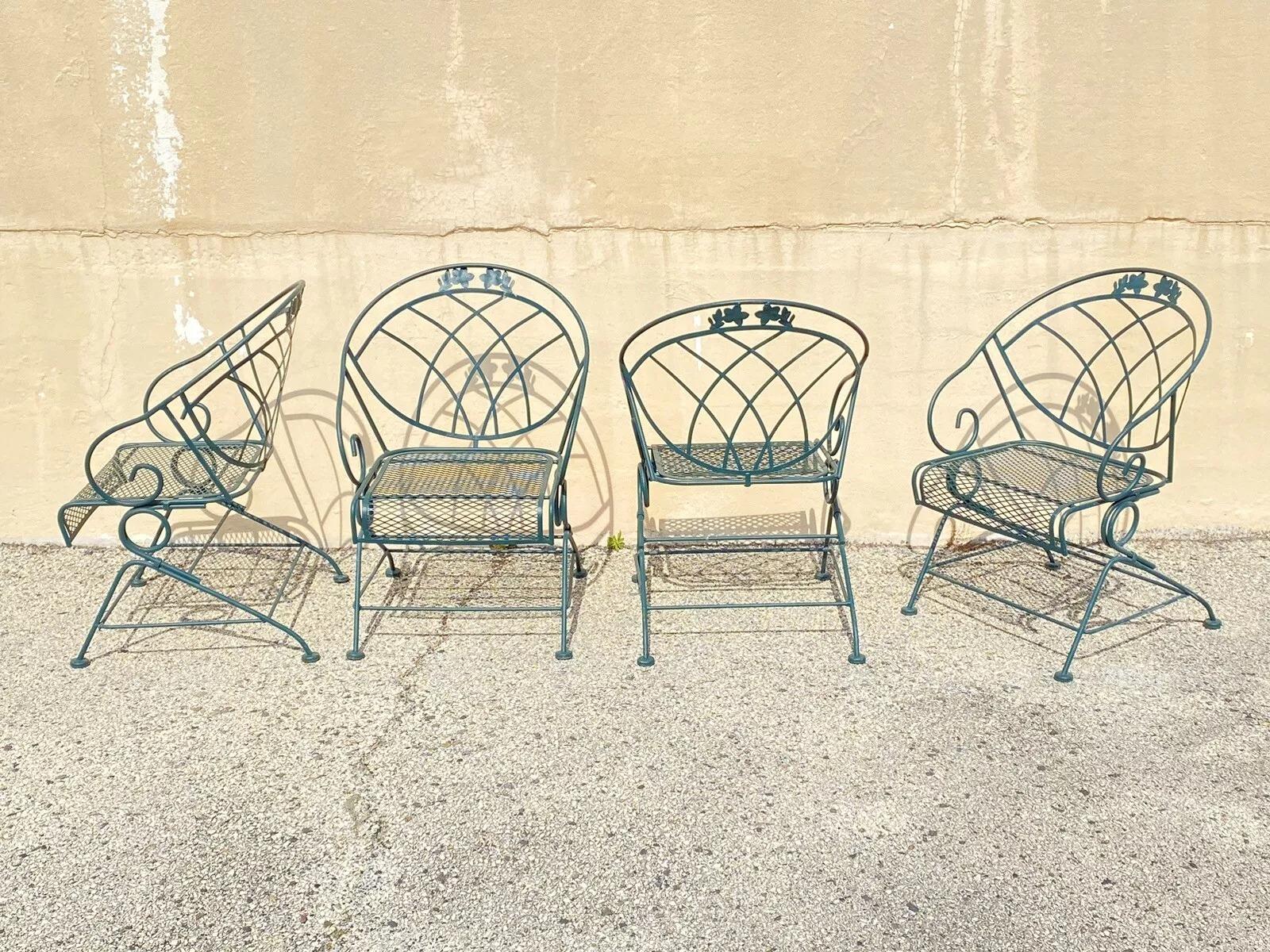 Vintage Woodard Wrought Iron Green Spring Bouncy Patio Dining Set - Set of 5. Item features w rought iron frames, round glass top with umbrella hole, green finish, scrolling frame, floral accents. Set includes (4) bouncy dining chairs, (1) round