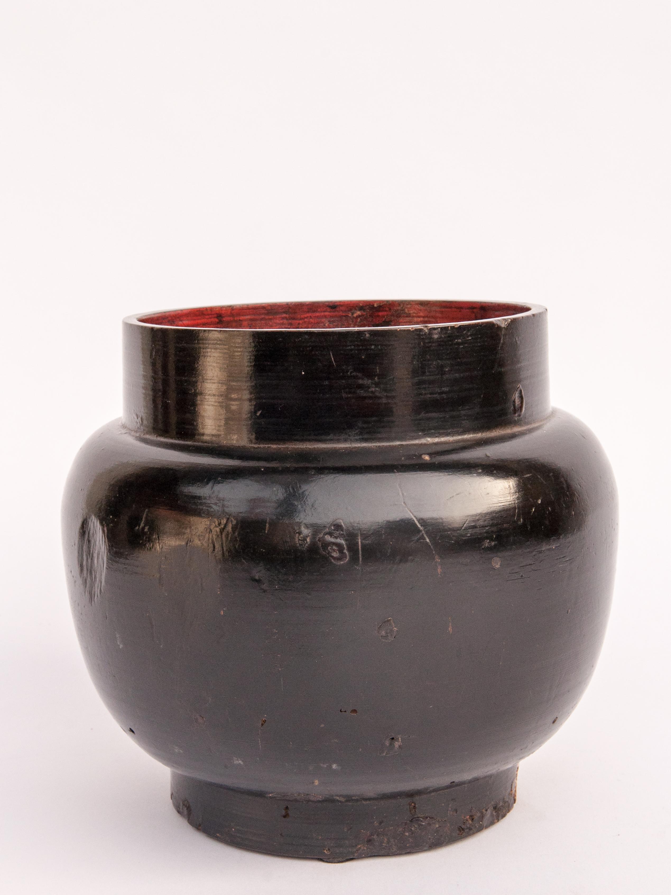 Vintage wooden beer pot from Bhutan, mid-20th century.
This pot was used as container for Tongpa, the ubiquitous fermented barley drink of the Tibetans. It is fashioned by hand from a single piece of wood, with a lacquered finish.
Condition: It is