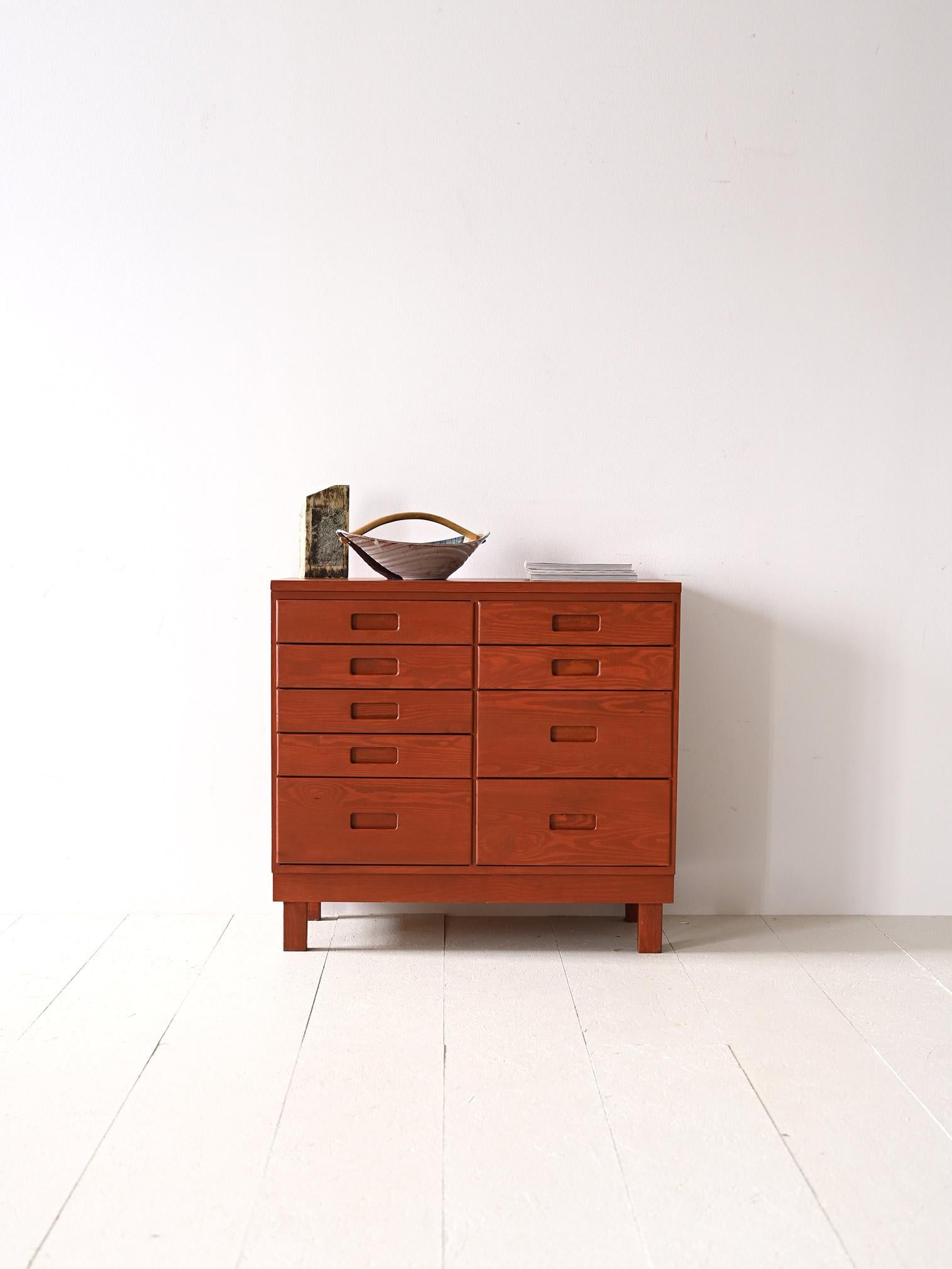 Scandinavian cabinet with 9 drawers

A modern furniture piece consisting of drawers of different sizes with the handle carved from wood.
The simple, square structure hints at the Nordic taste of mid-century design.
Due to its small size and numerous