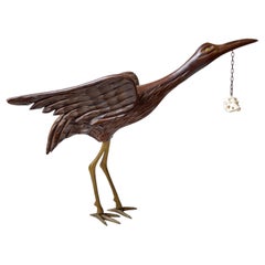 Escultura vintage de madera de pájaro grulla con cráneo suspendido