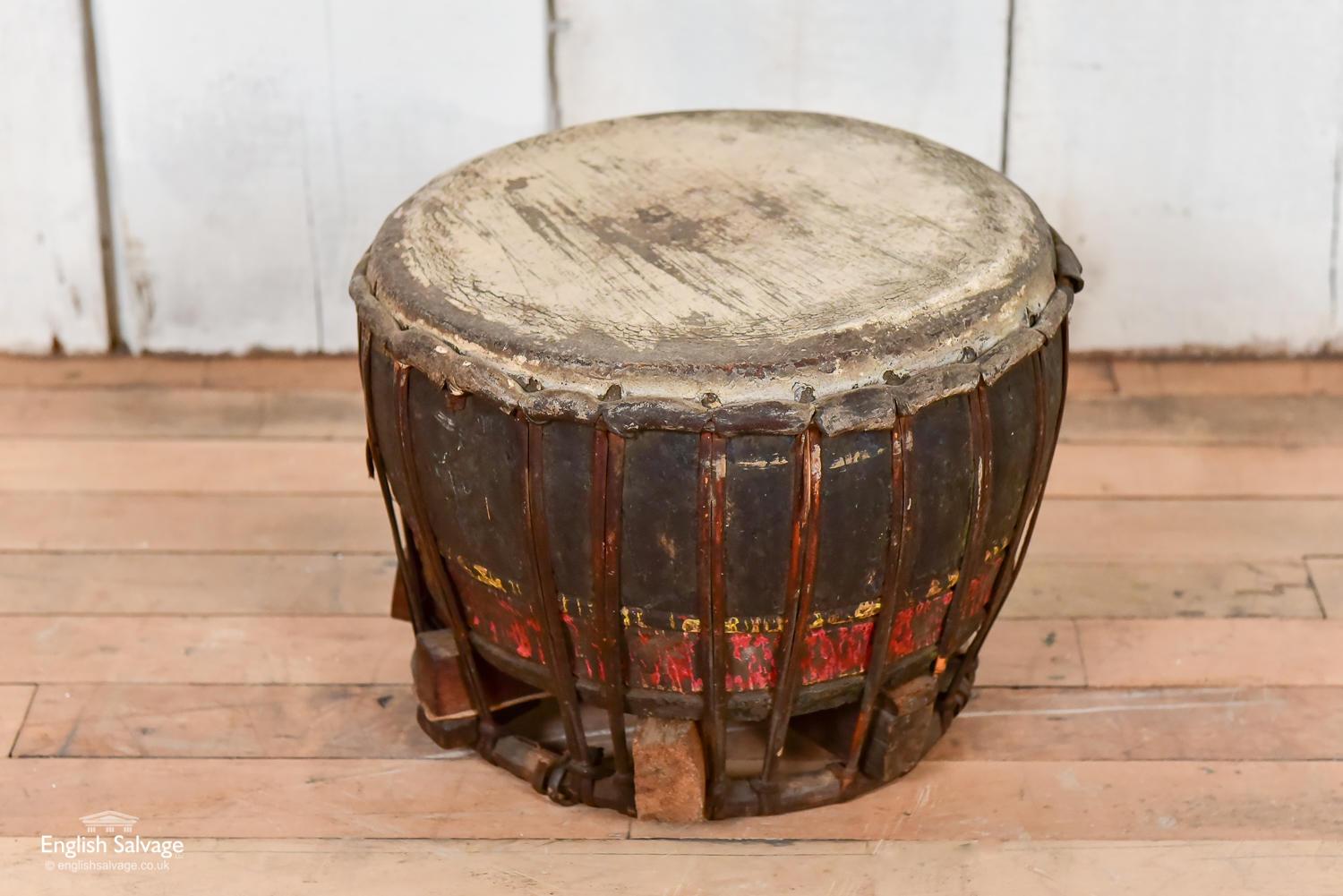 Old drum made of wood and parchment or skin [we're not sure which], with leather fastenings. It is weathered and scratched but has a lovely sound.
