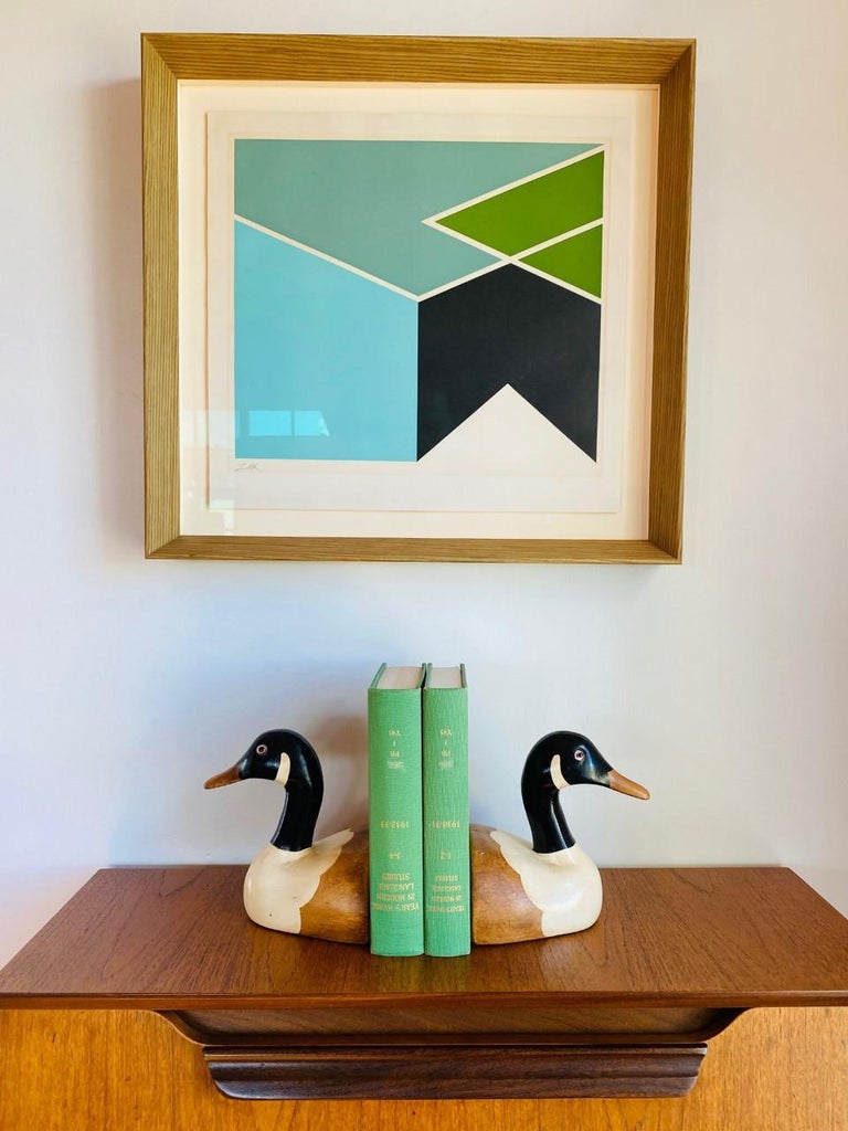 Beautifully sculpted and incredibly nostalgic pair of wooden duck bookends. These realistic looking, duck bookends have a timeless and classic look. Made in the 1970's, these rare bookends are in excellent condition. Masterfully crafted in real