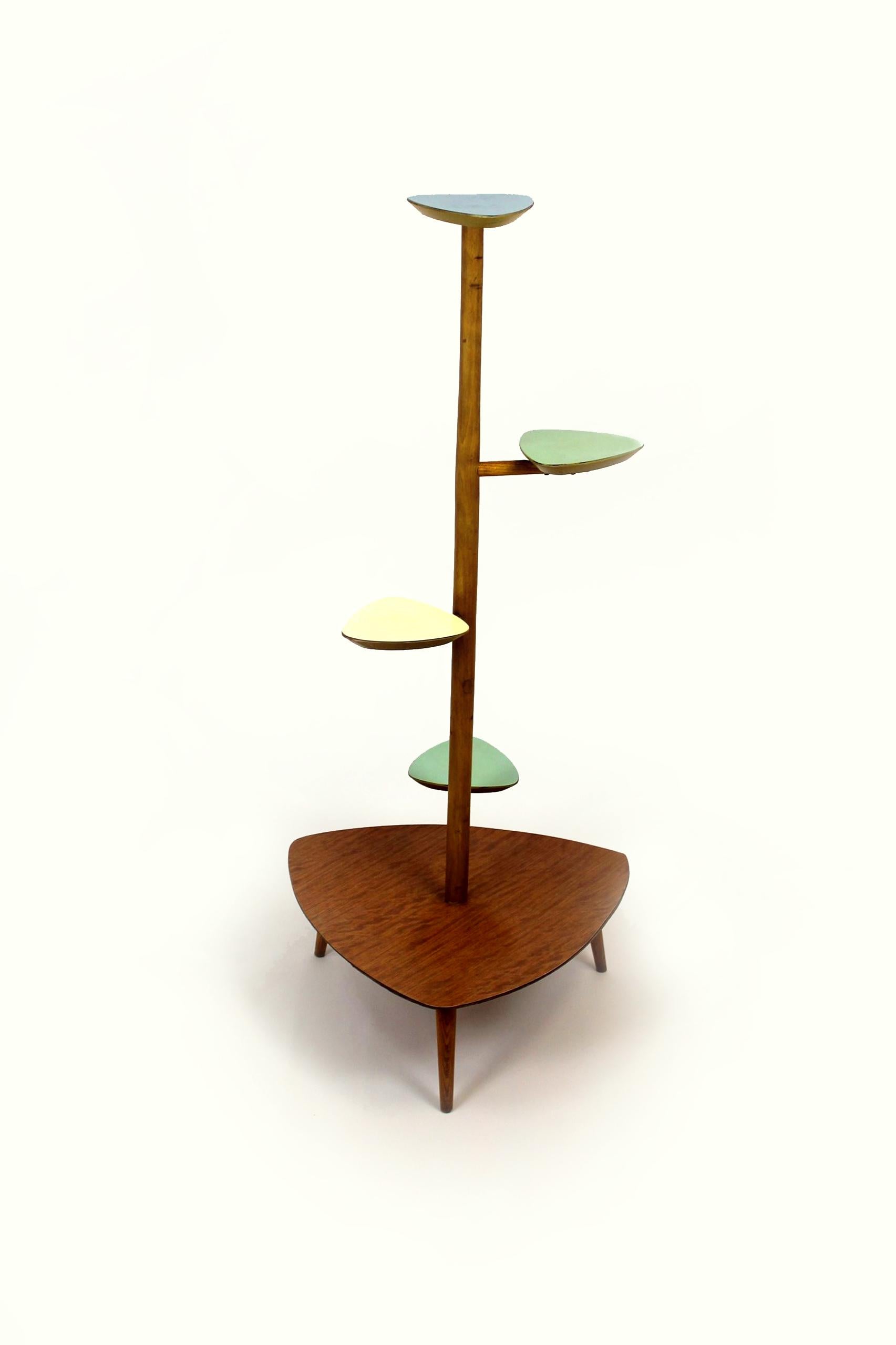 This flower stand is made of wood and formica. It was produced in the Czech Republic in the 1960s.
 