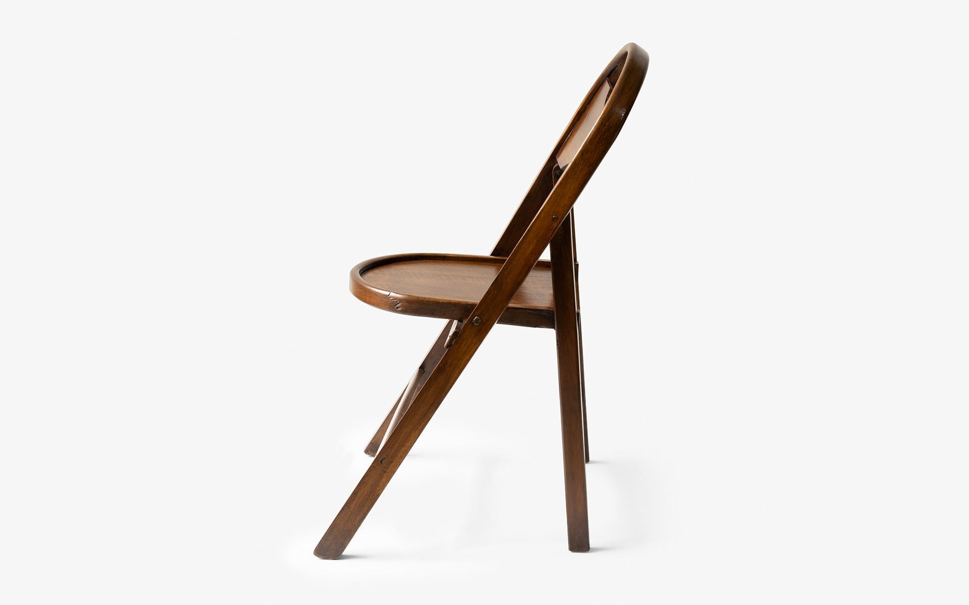 This folding wooden chair, which is a rare vintage item found in the 