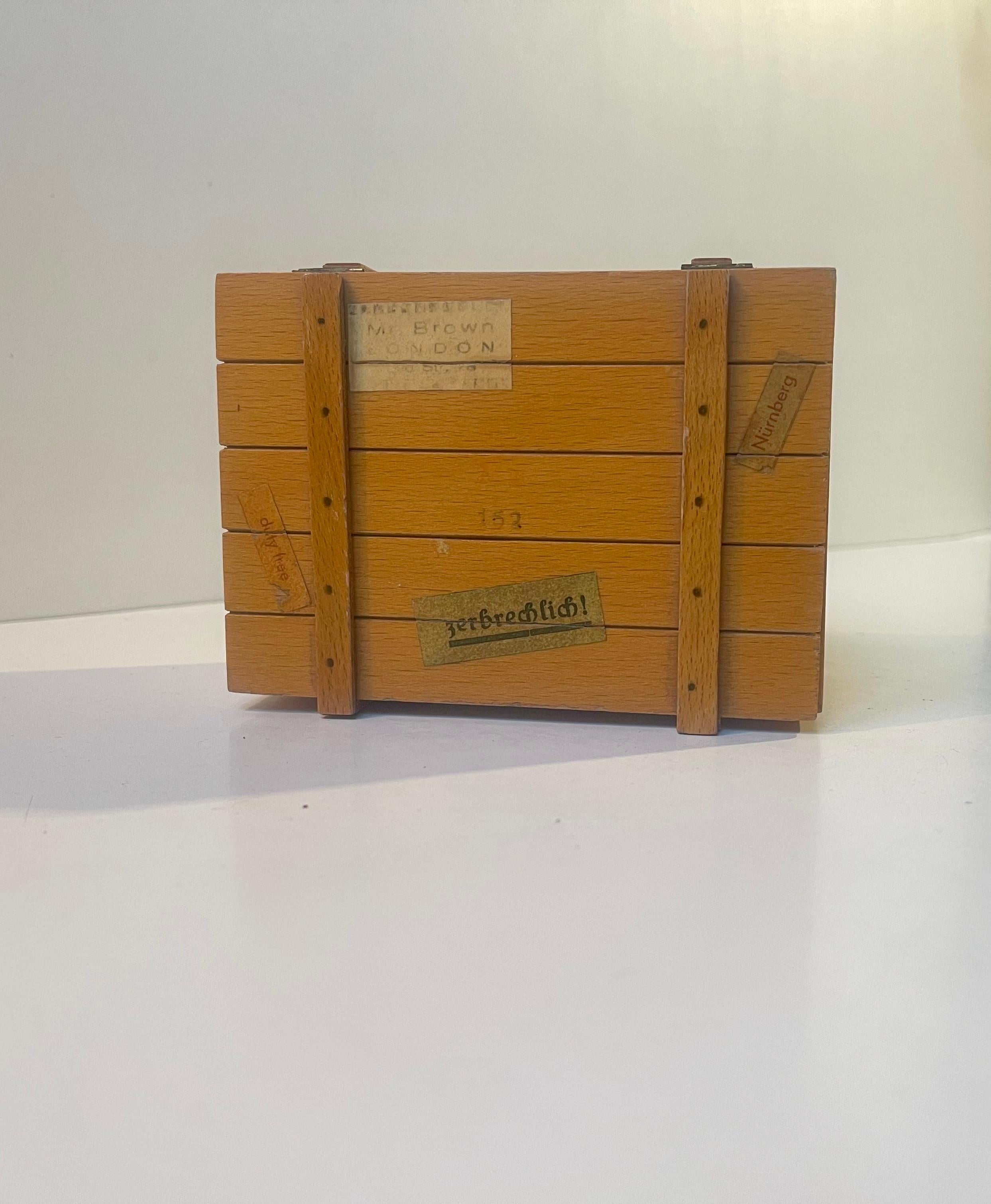 Eine deutsche Neuheit aus den 1960er Jahren in Form dieser hübschen Reisekoffer-Spieldose. Es ist in hellem Holz ausgeführt - wahrscheinlich Kiefer - und kommt mit Papieretiketten aus verschiedenen deutschen Städten, Namen des Reisenden, einem Duty