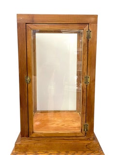 Vintage Wooden Glass Display Cabinet with Hinged Door and Brass Toned Hardware.