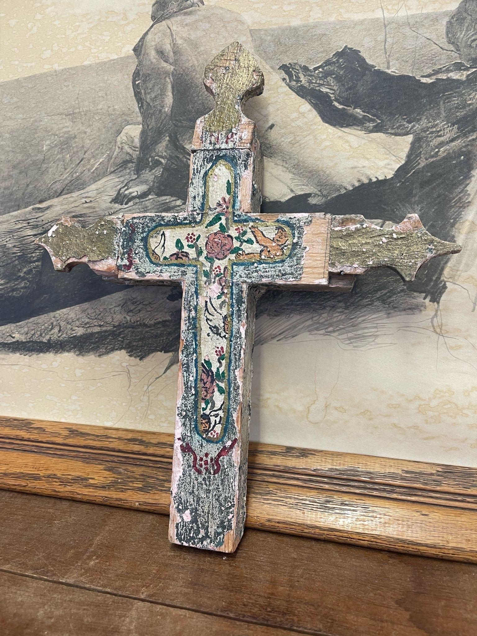 Cross with Beautiful Aging and Petina to the Paint and Wood. Floral and Angel Motifs. Pink and Green Toned Color,with Gold Tones at the Tip of the Cross. Possibly of Mexican Origin. Vintage Condition Consistent with Age as Pictured.

Dimensions. 12